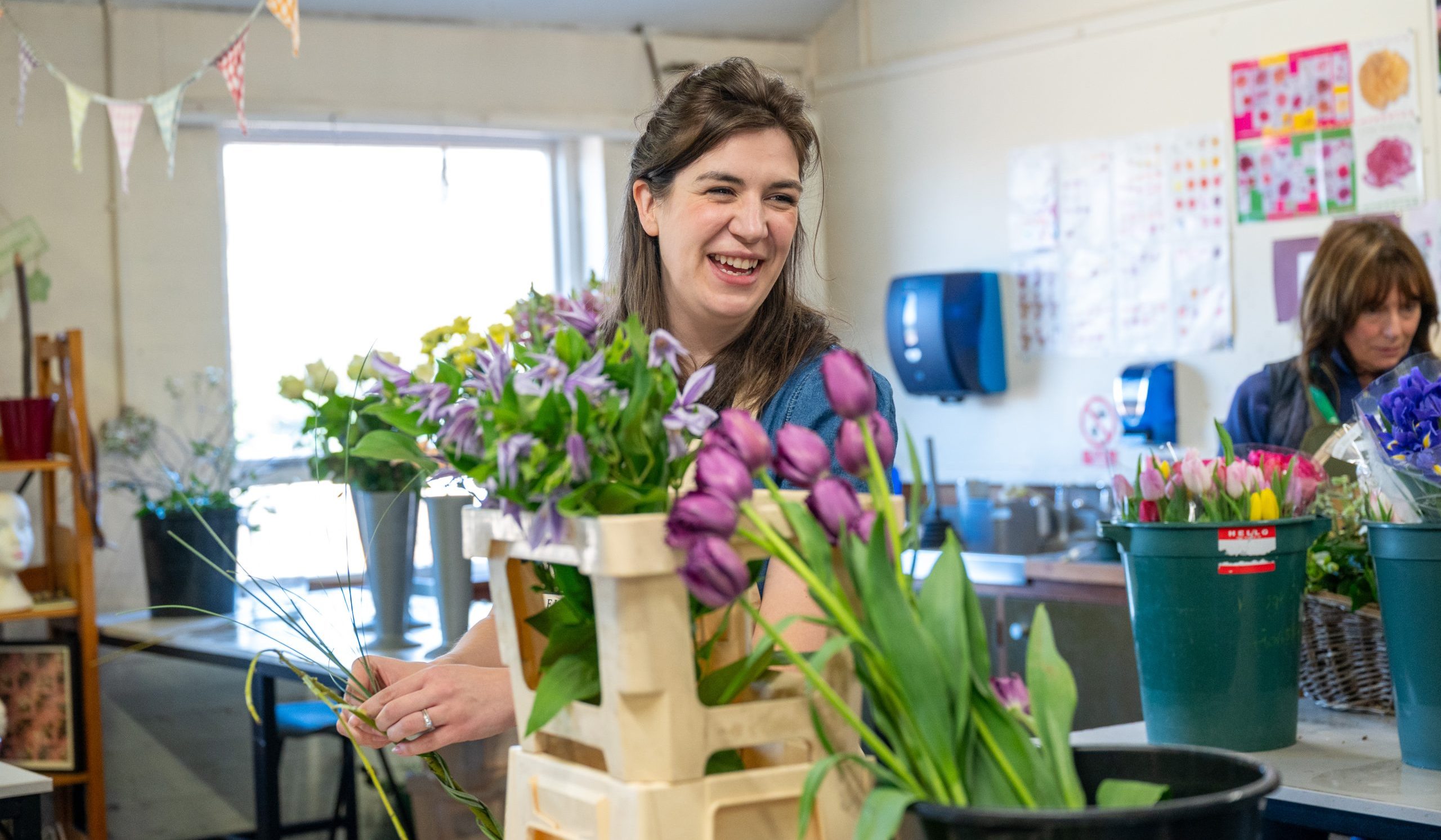 Image of floristry student adjusting flowers