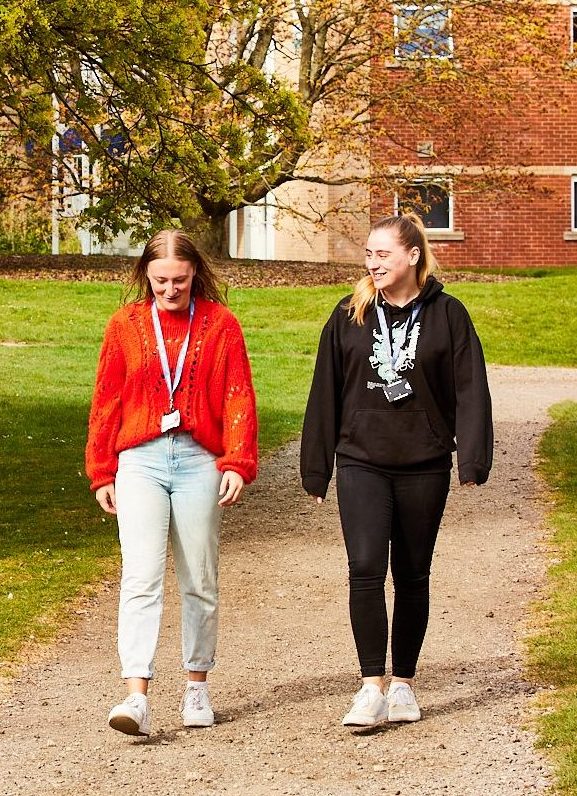 Two students walking on campus