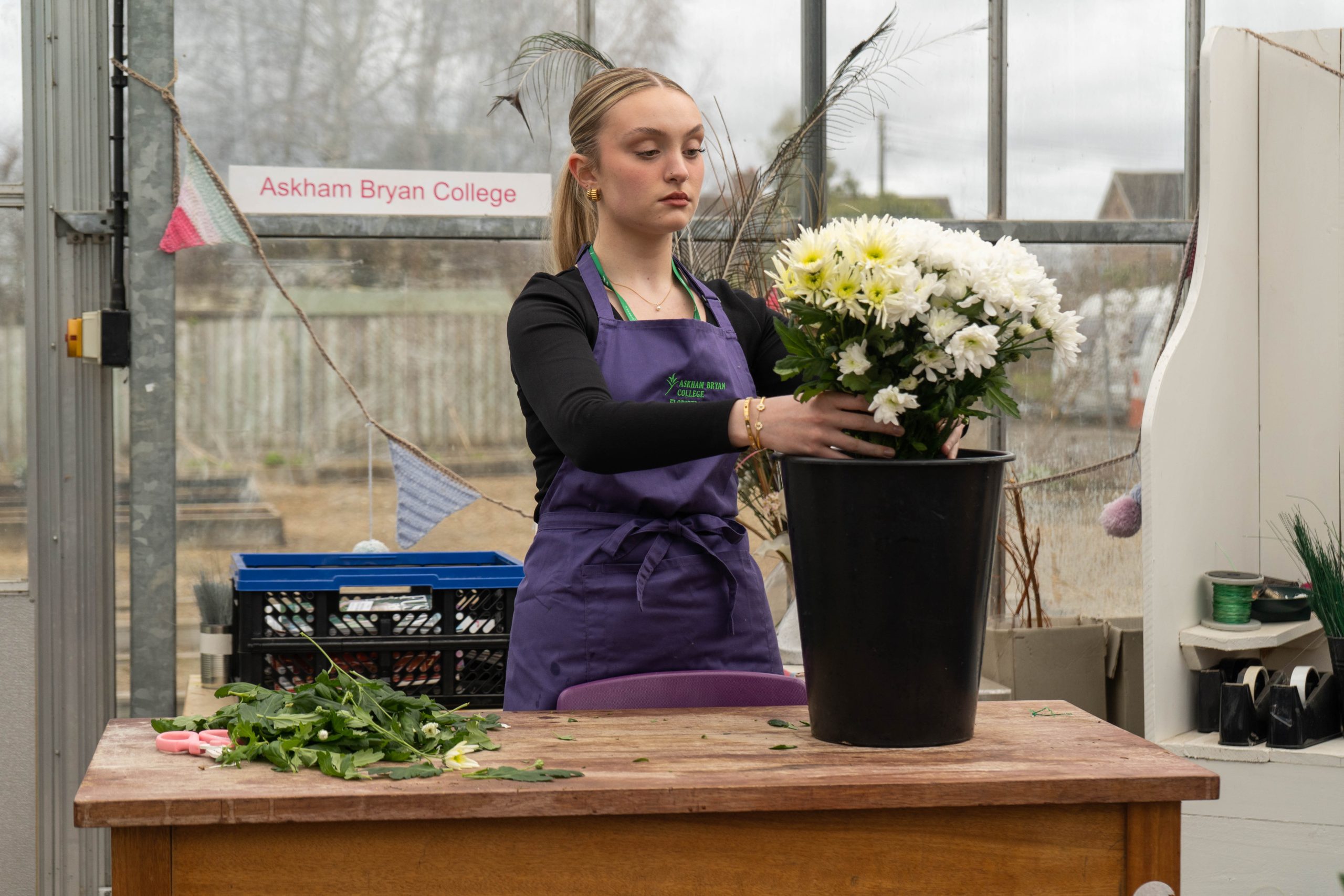 Image of a floristry student creating a bouquet