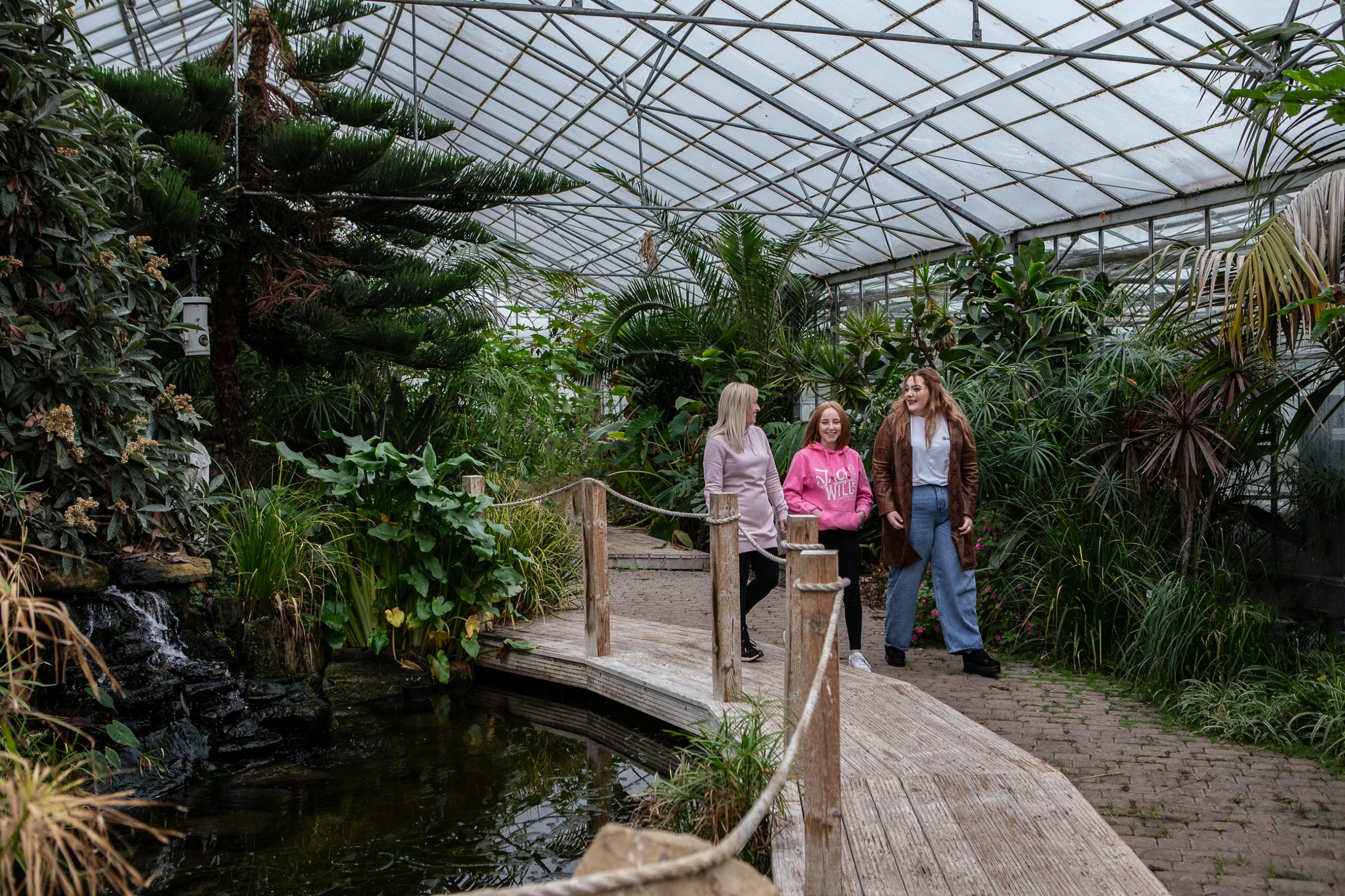 Image of three students walking in the greenhouse