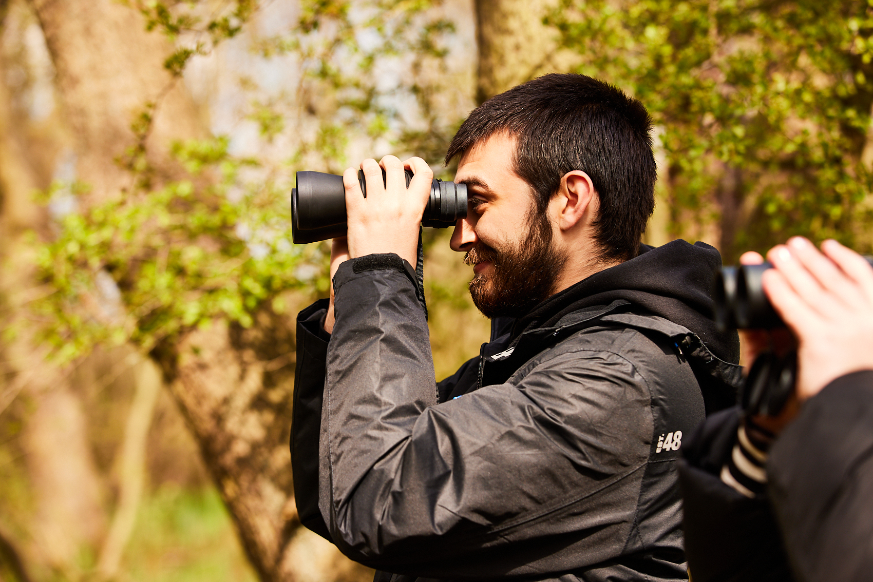 A man looking through binoculars