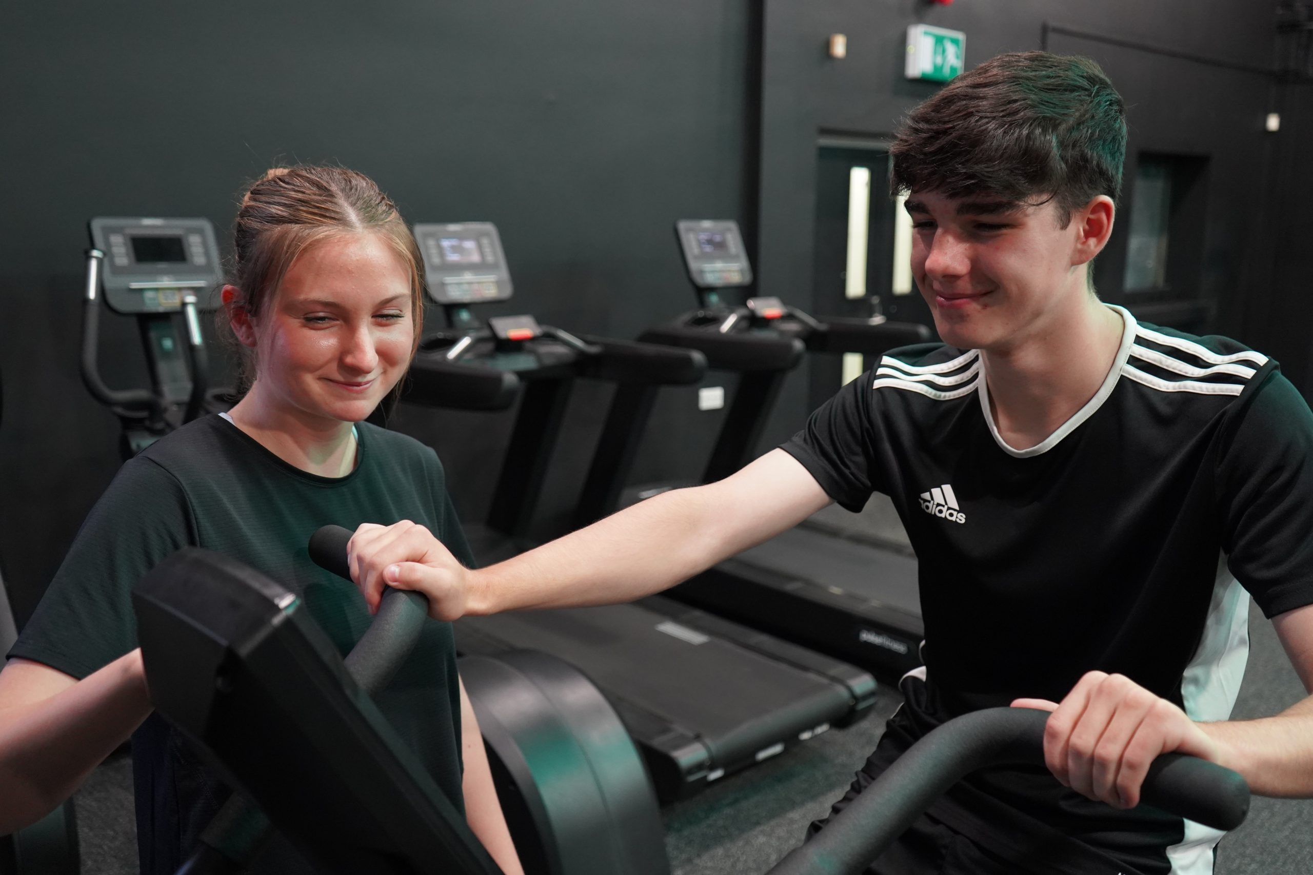 Image of two students coaching each other in the gym