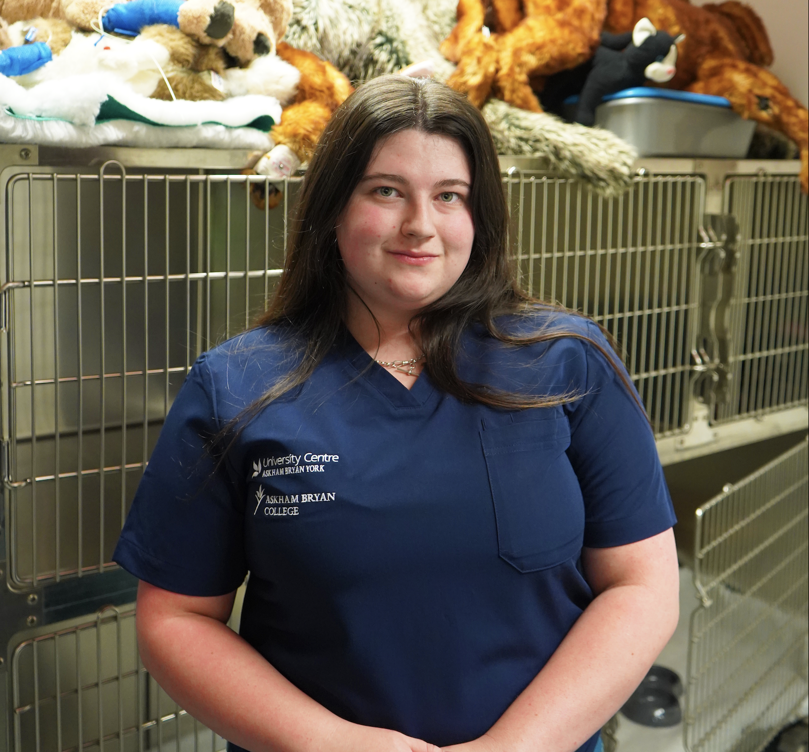Image of a vet nursing student in front of kennels