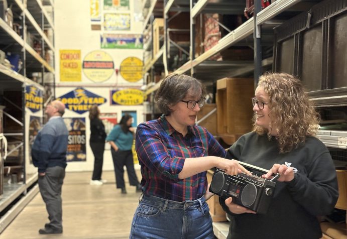 Figures looking at objects within the collections.