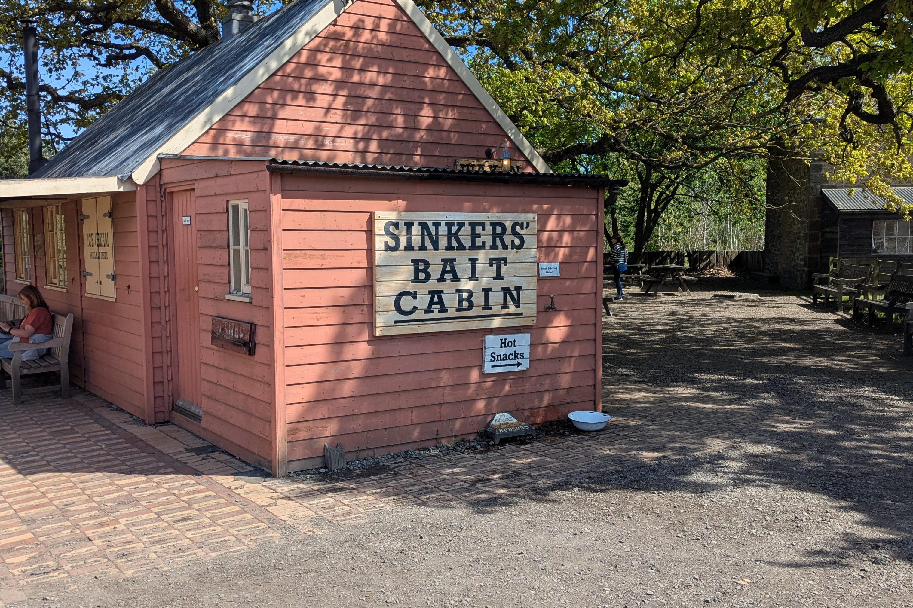 Wooden cabin with sign saying 'Sinkers' Bait Cabin'.