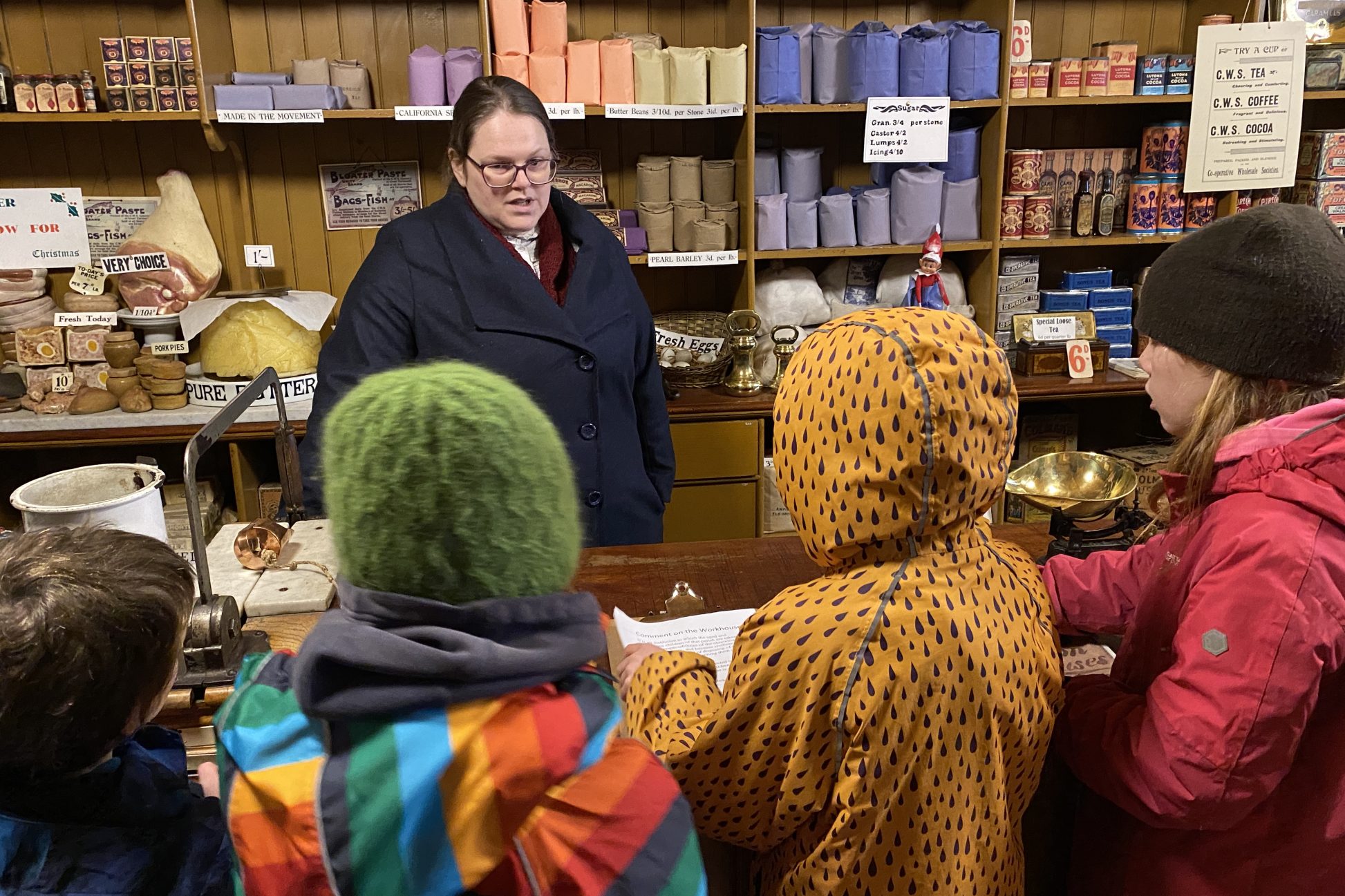 Beamish staff member chatting with group of young people.