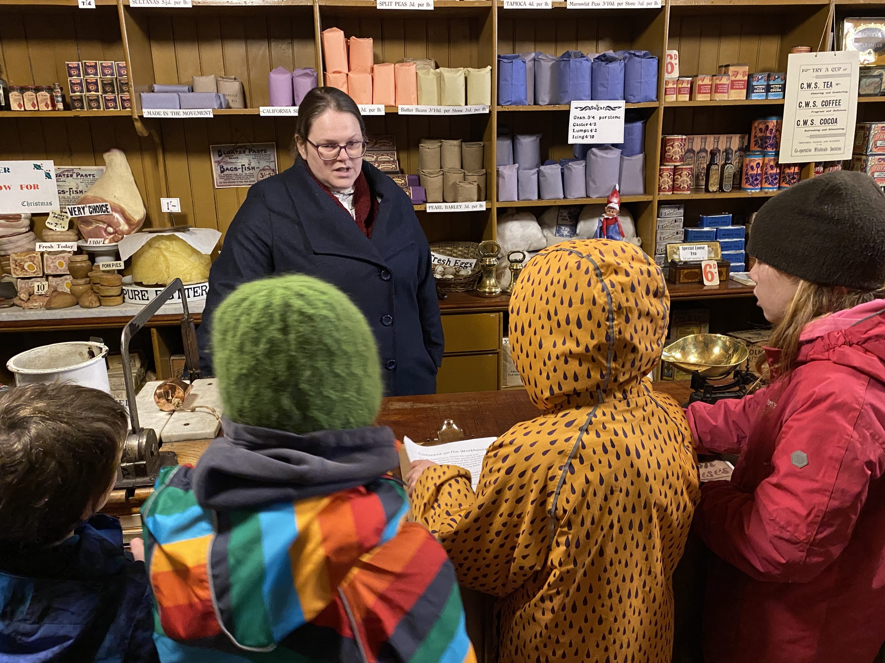 Beamish staff member chatting with group of young people.