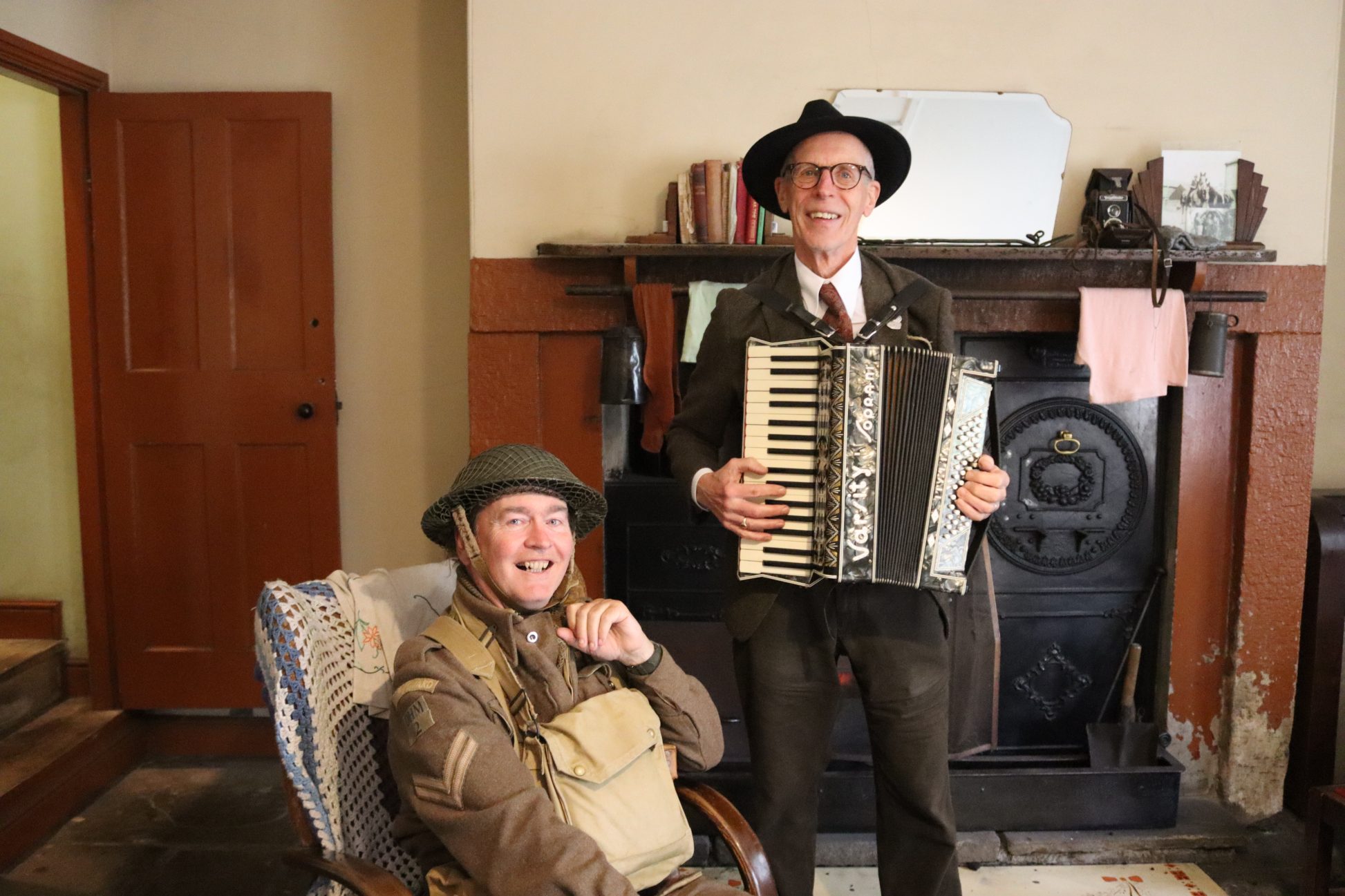 Two staff members dressed in 1940s costume.