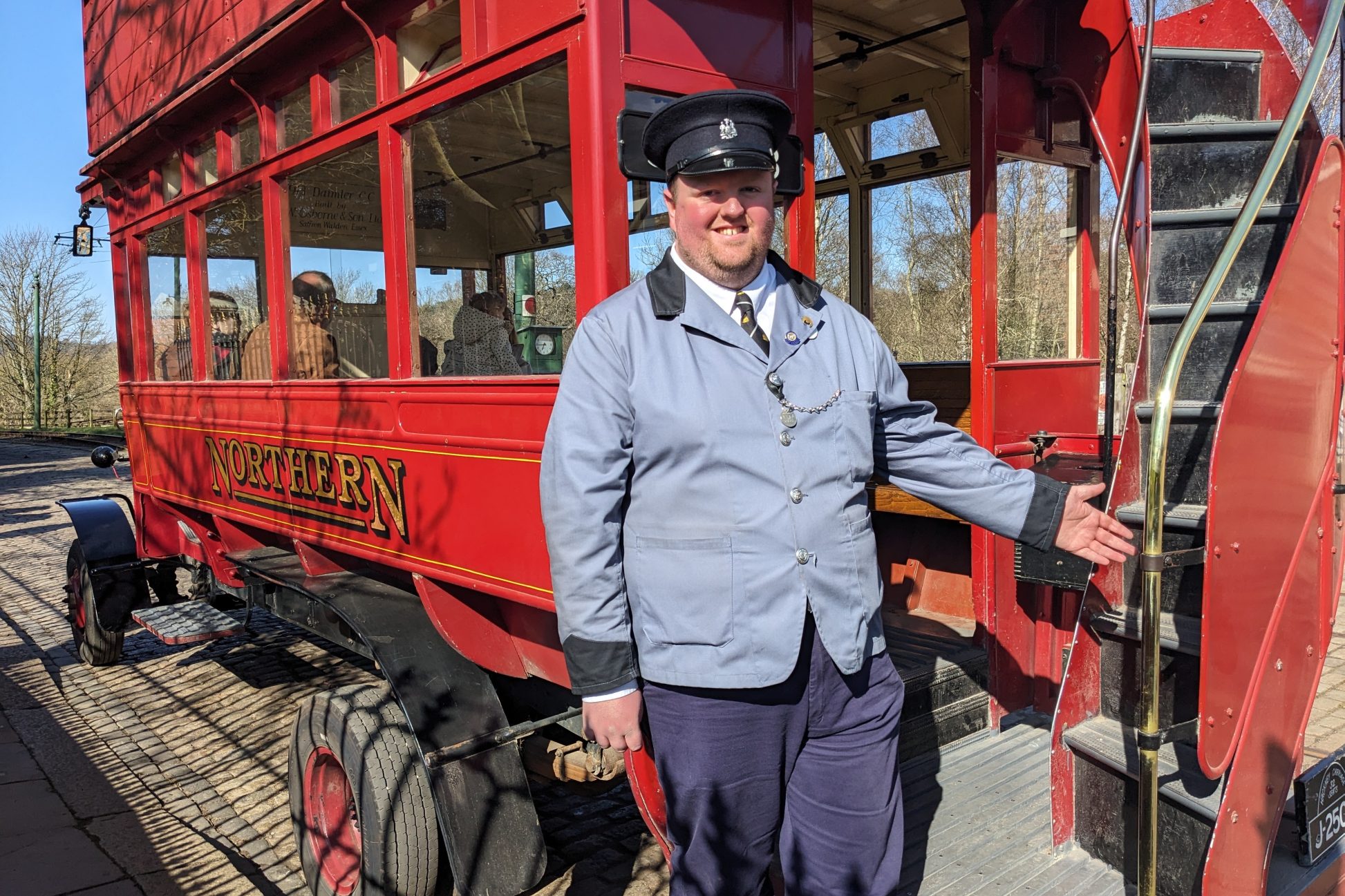 Conductor at the back of vintage bus.