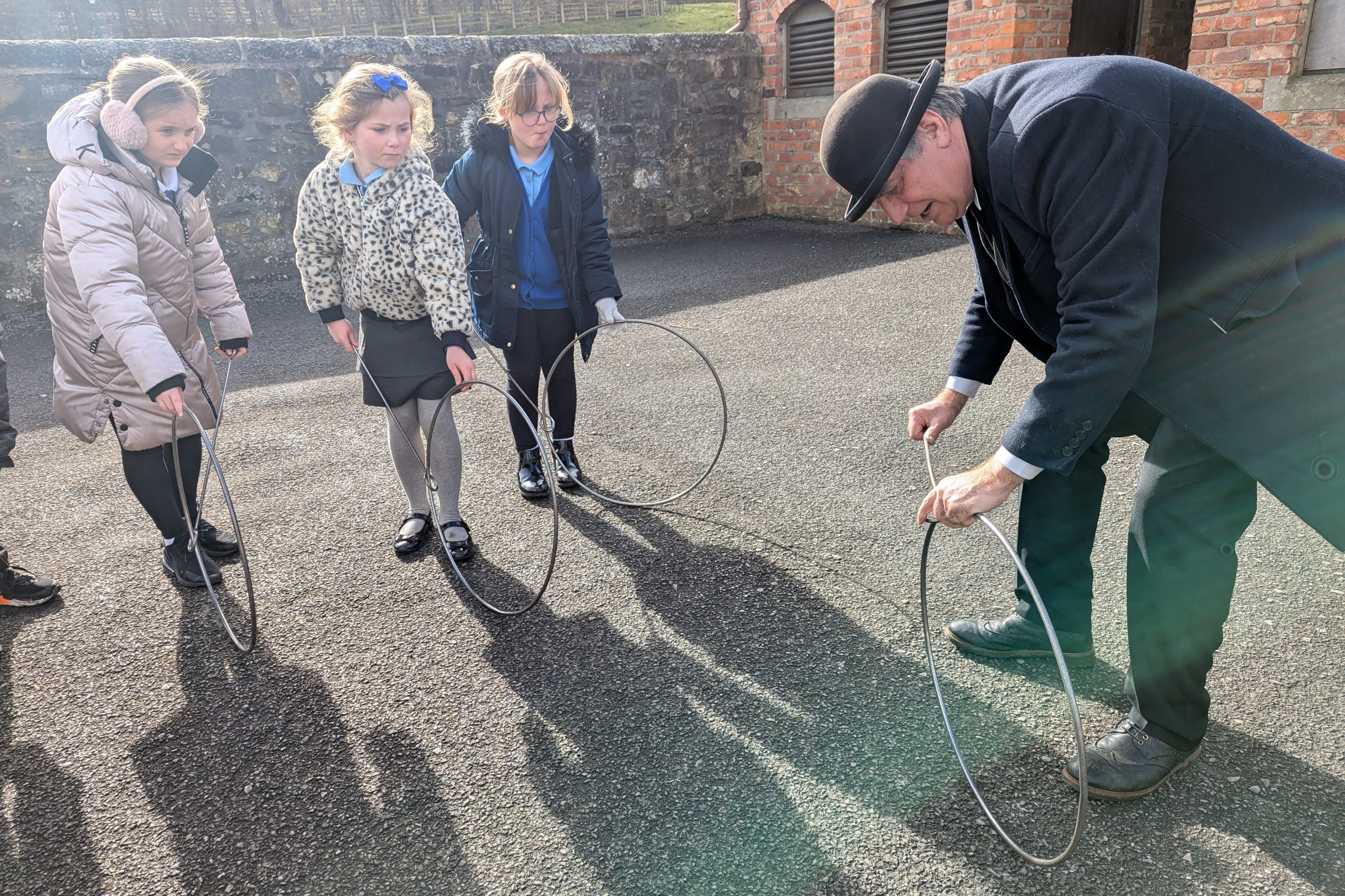 School children with costumed staff member in 1900s Pit Village.