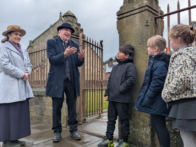 School children with costumed staff member in 1900s Pit Village.