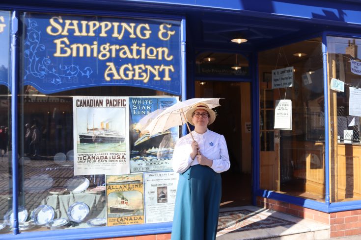 Staff member wearing Edwardian costume in 1900s Town.