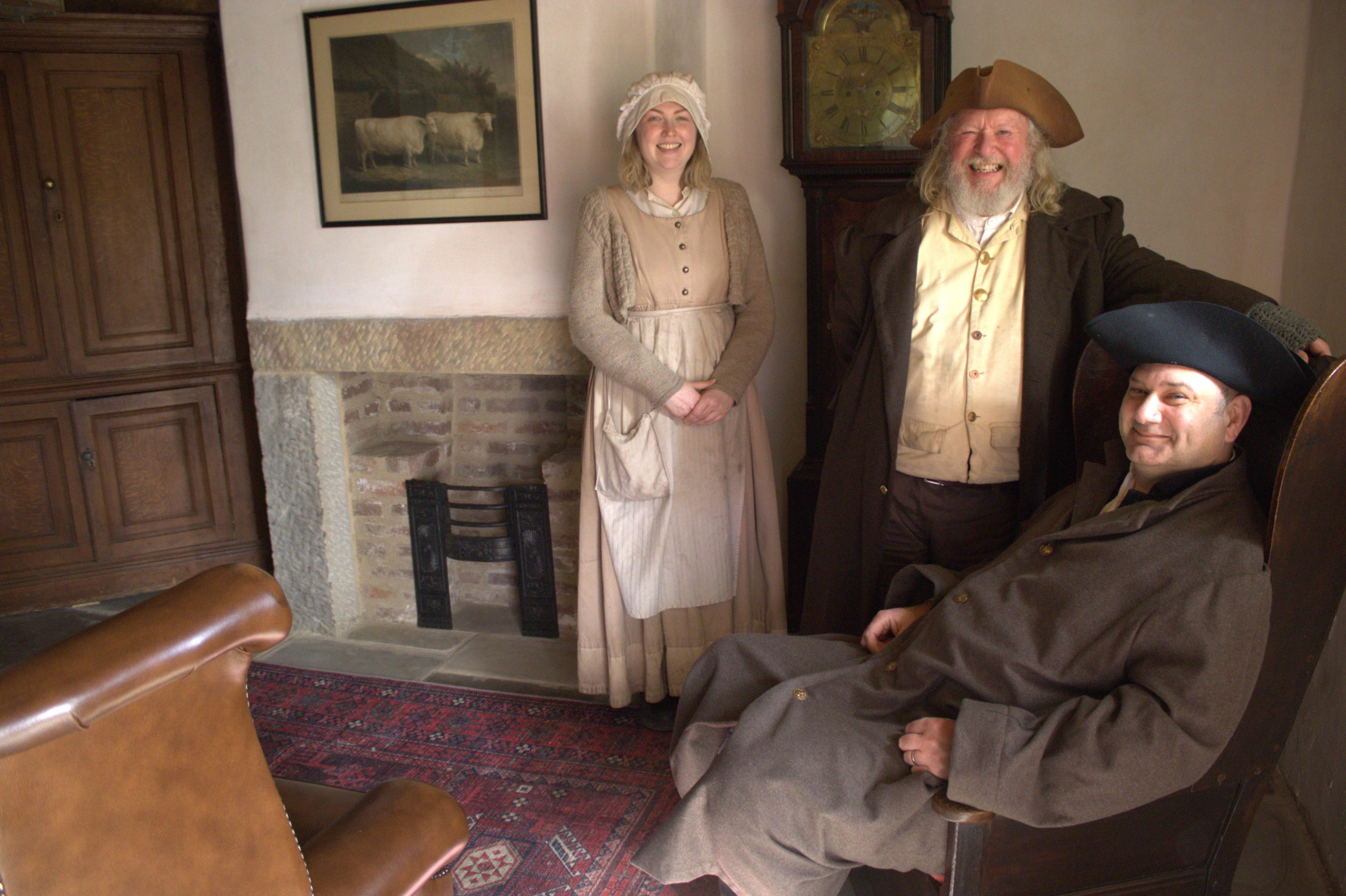 Costumed staff inside Georgian accommodation.