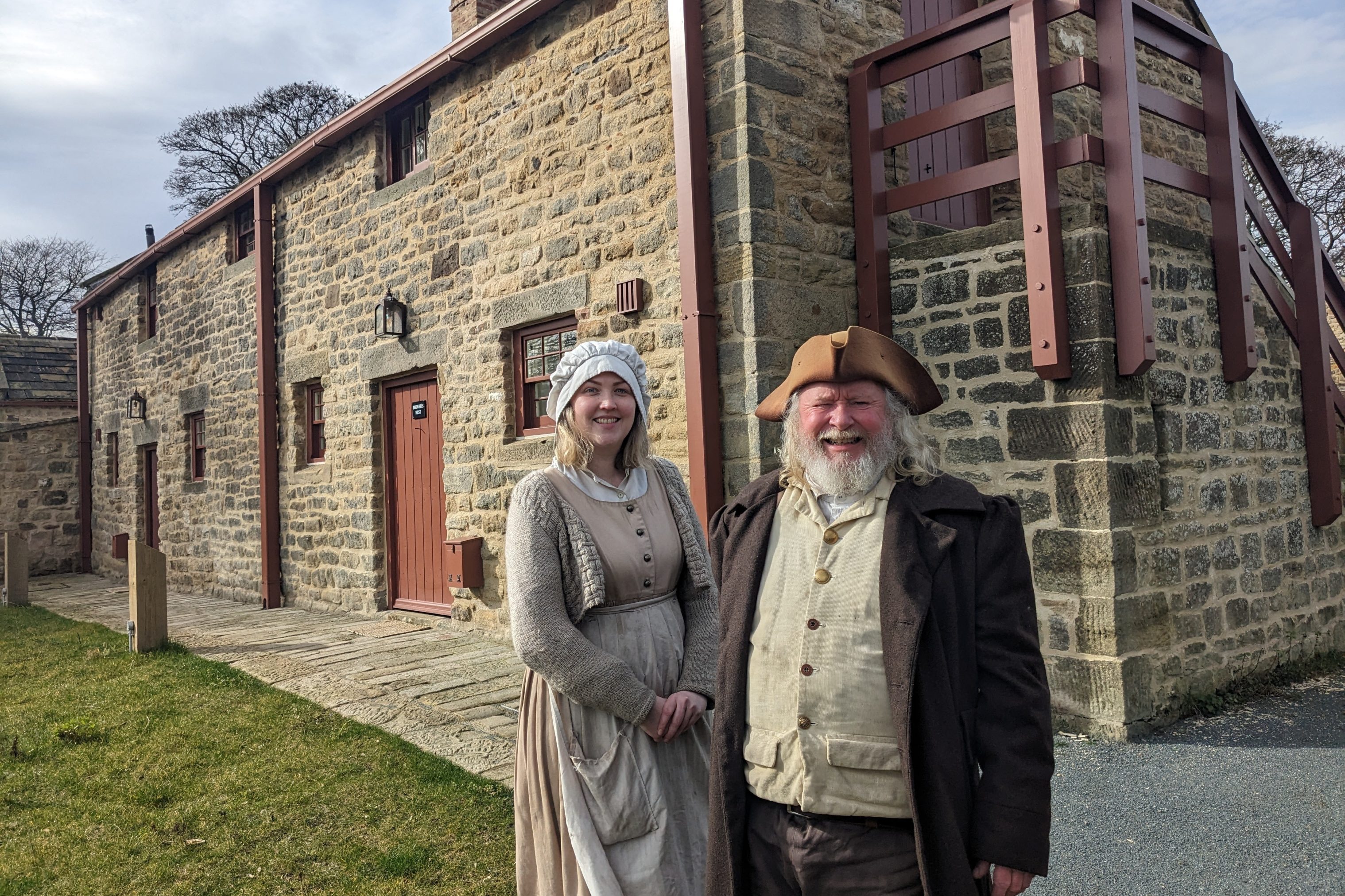 Costumed staff in front of Georgian accommodation.