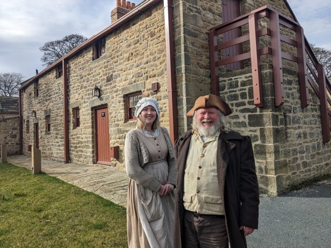 Costumed staff in front of Georgian accommodation.