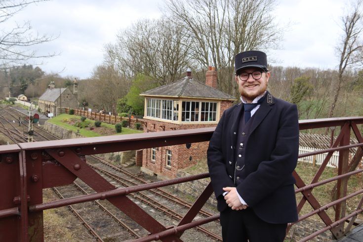 Smiling staff member on station bridge.