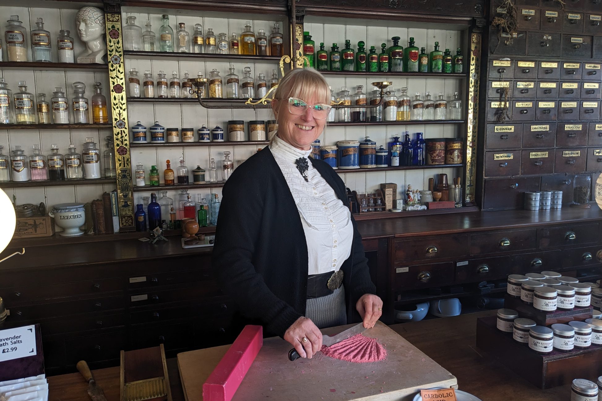 Costumed staff member chopping carbolic soap.