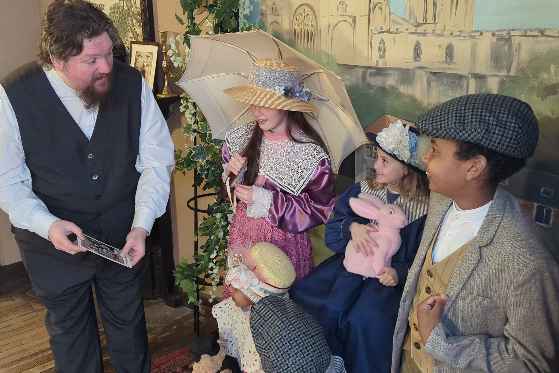 Costumed staff member talking to children in costume.