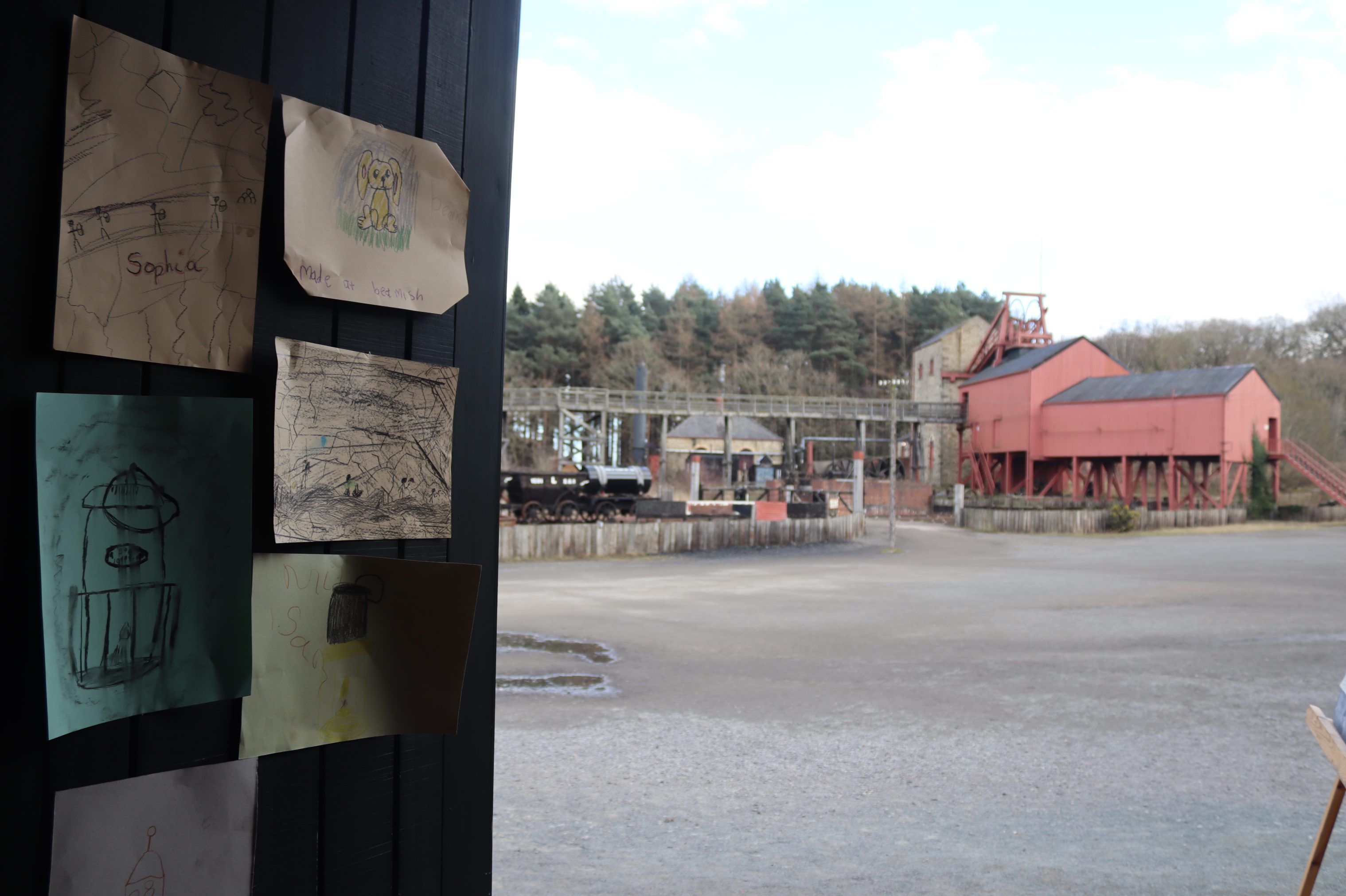 View of colliery yard, with children's drawings in the foreground.