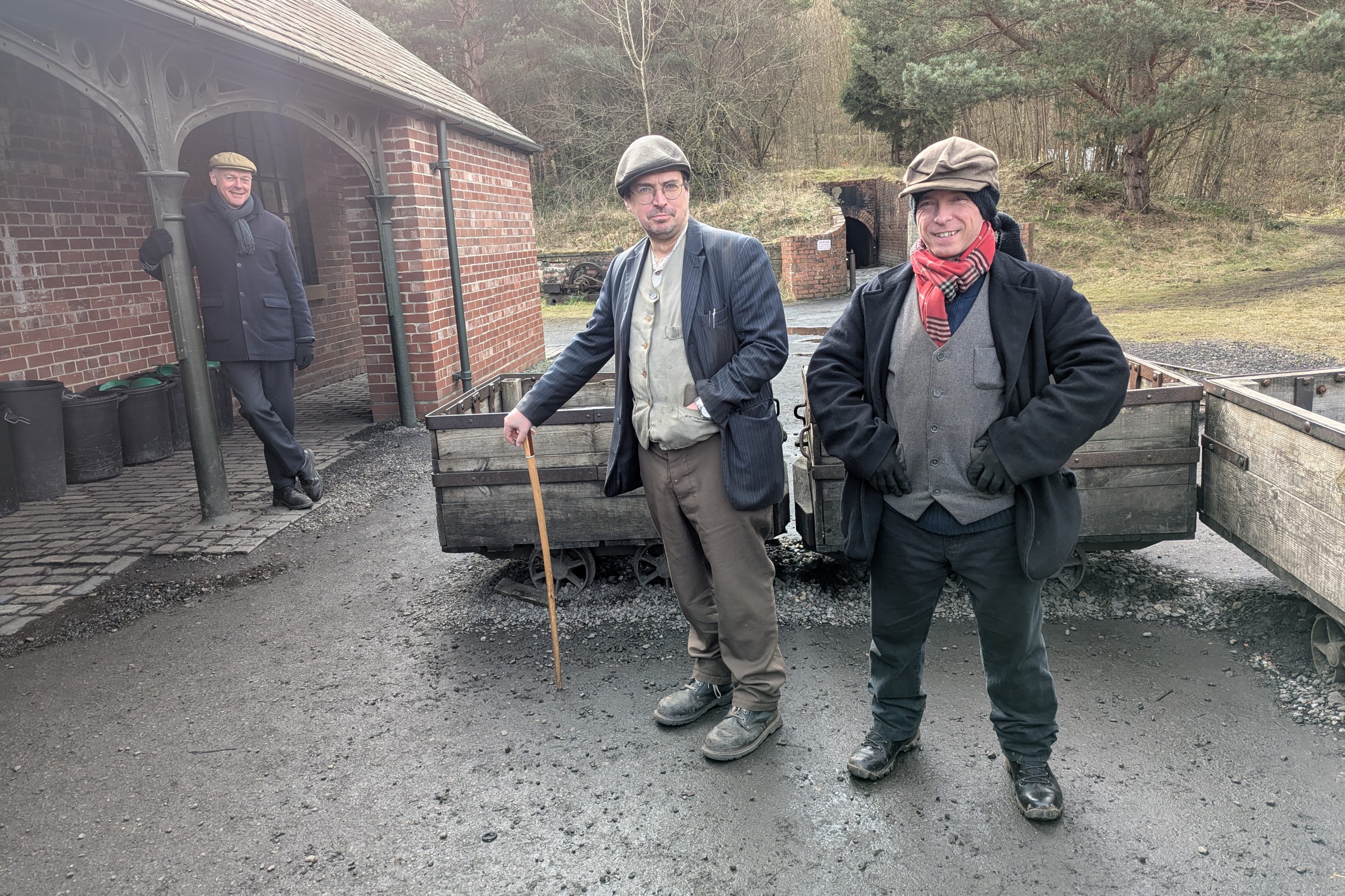 Three staff members outside drift mine.