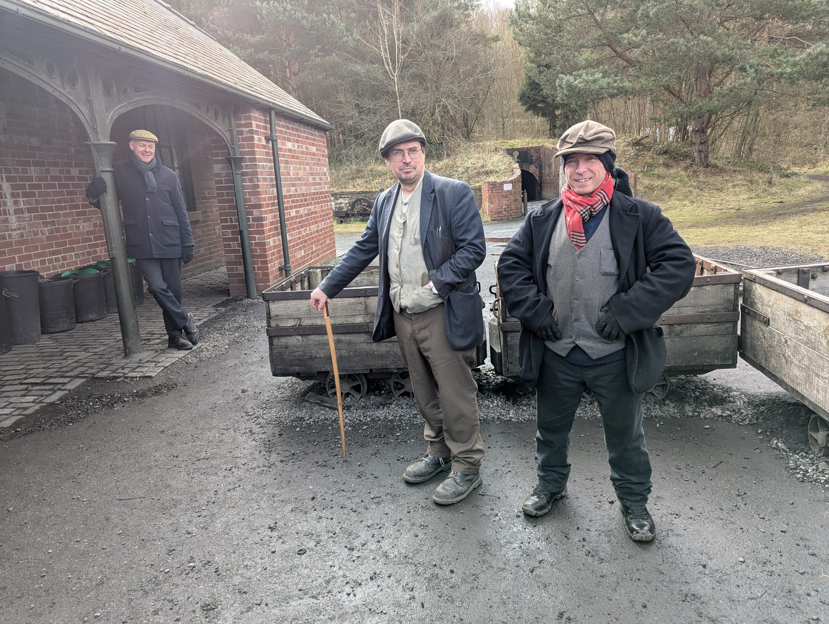 Three staff members outside drift mine.