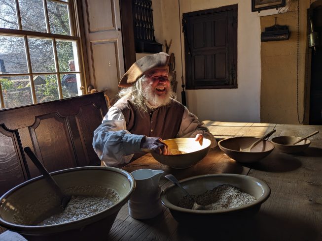 Costumed staff member smiling.