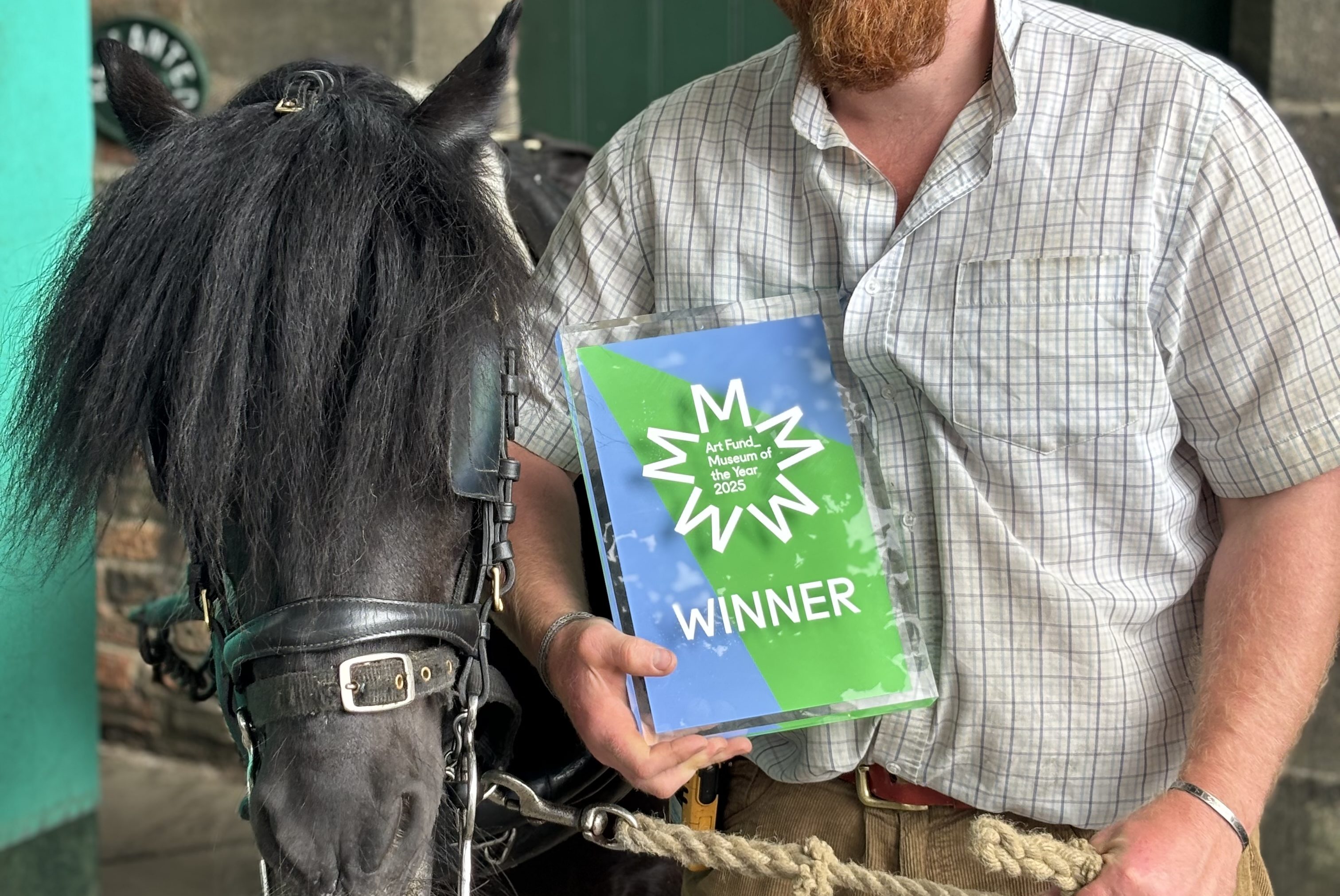 Figure holding award with pit pony.