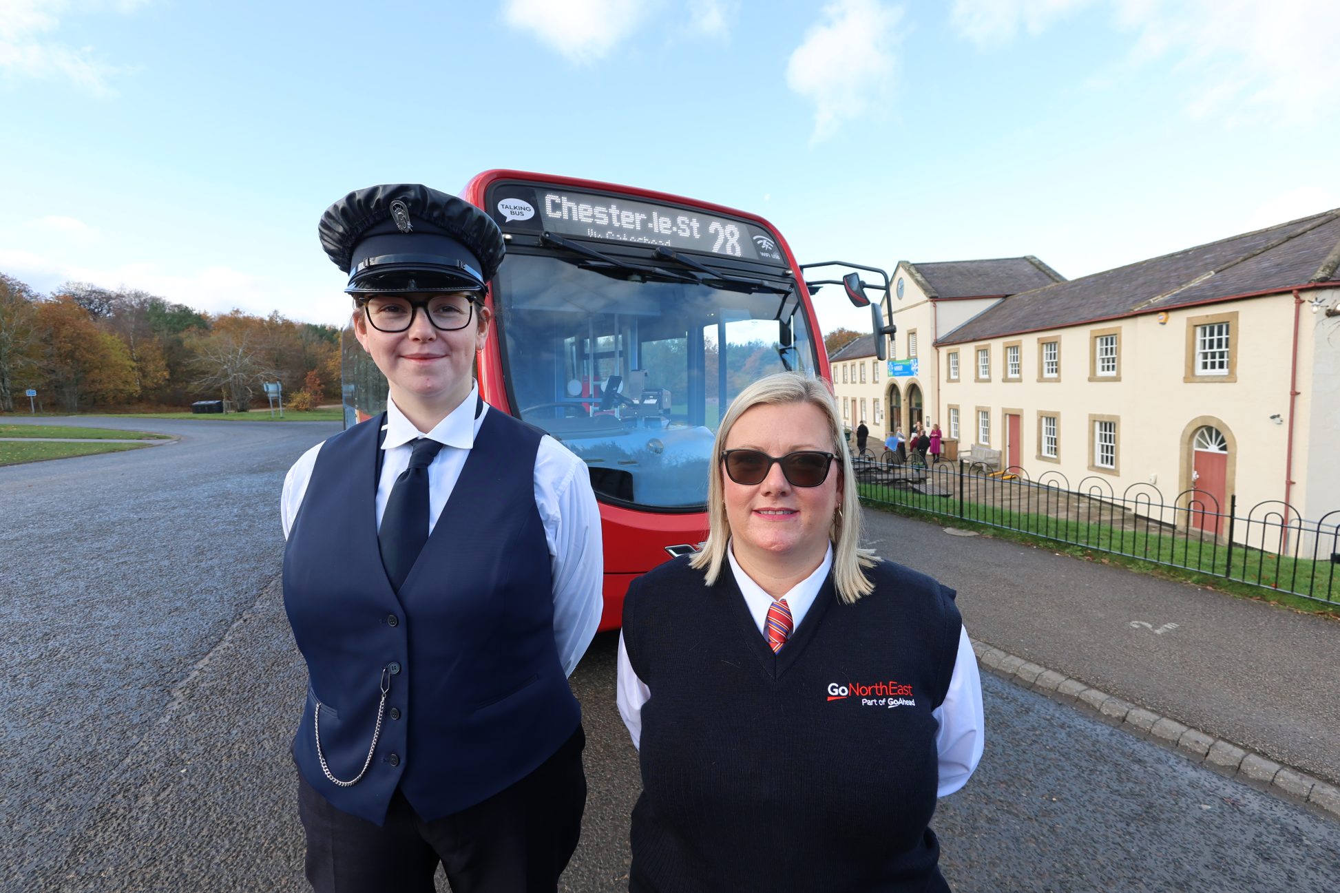 Two figures stood in front of Go North East Bus.