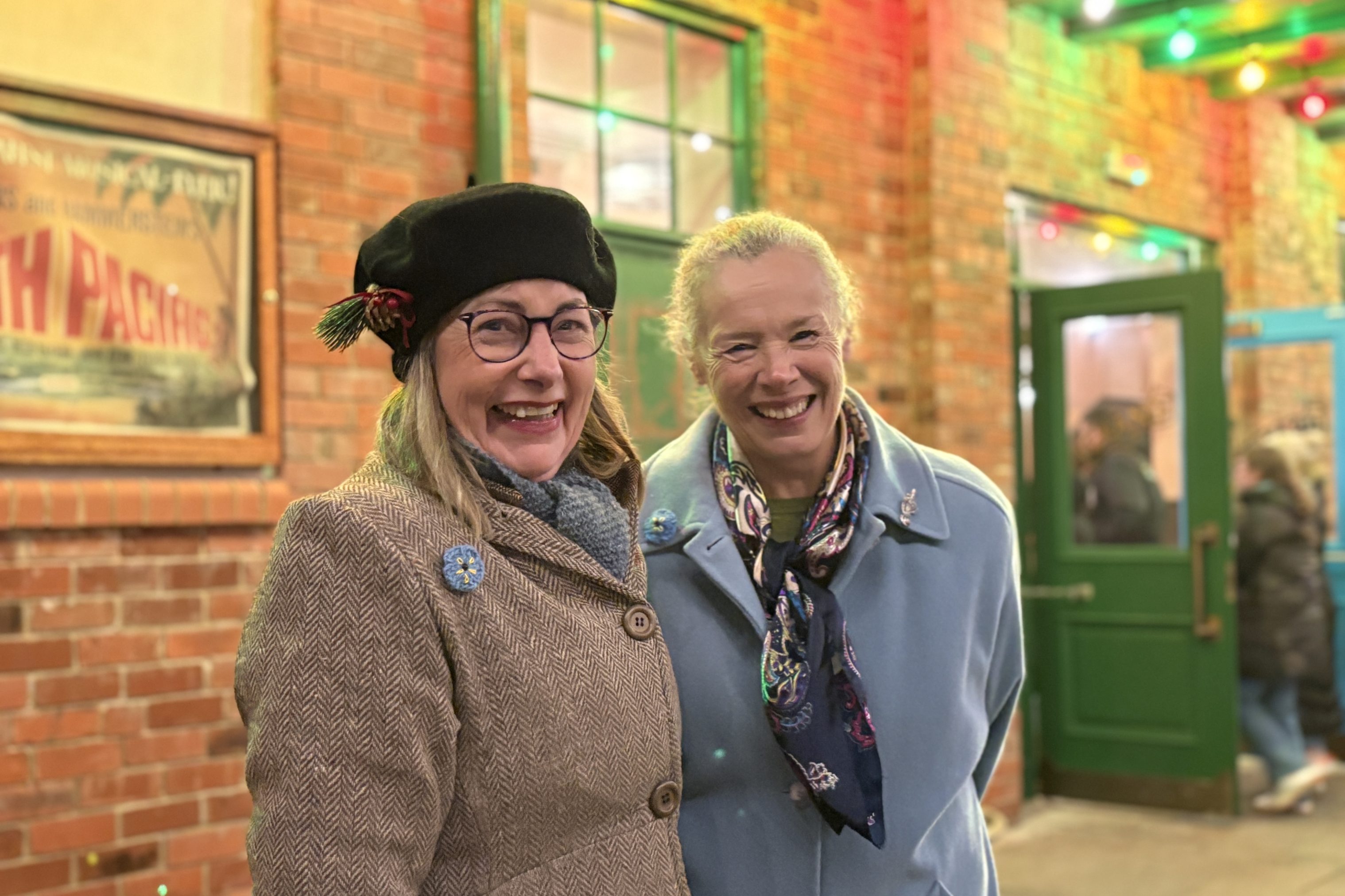 Two smiling staff members.