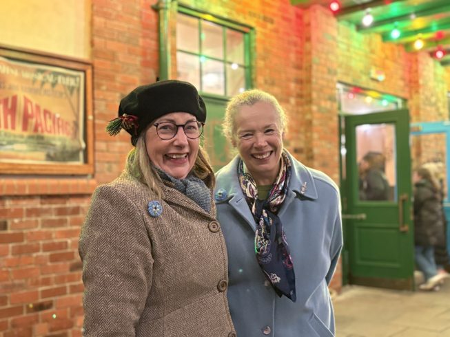 Two smiling staff members.