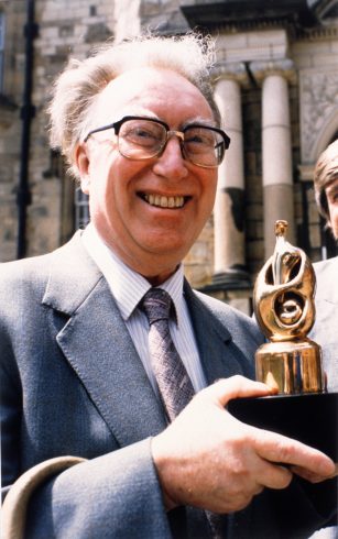 Figure holding trophy.