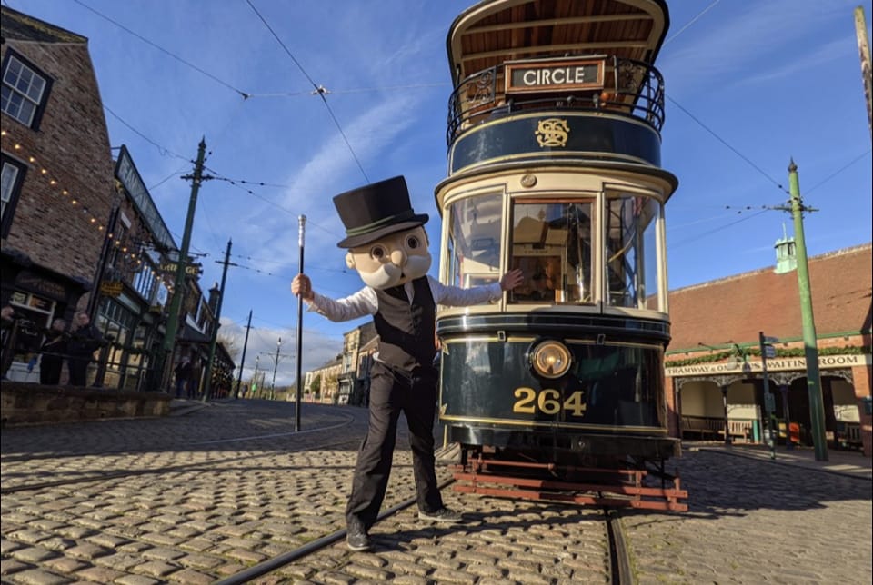 The Monopoly man in front of a tram