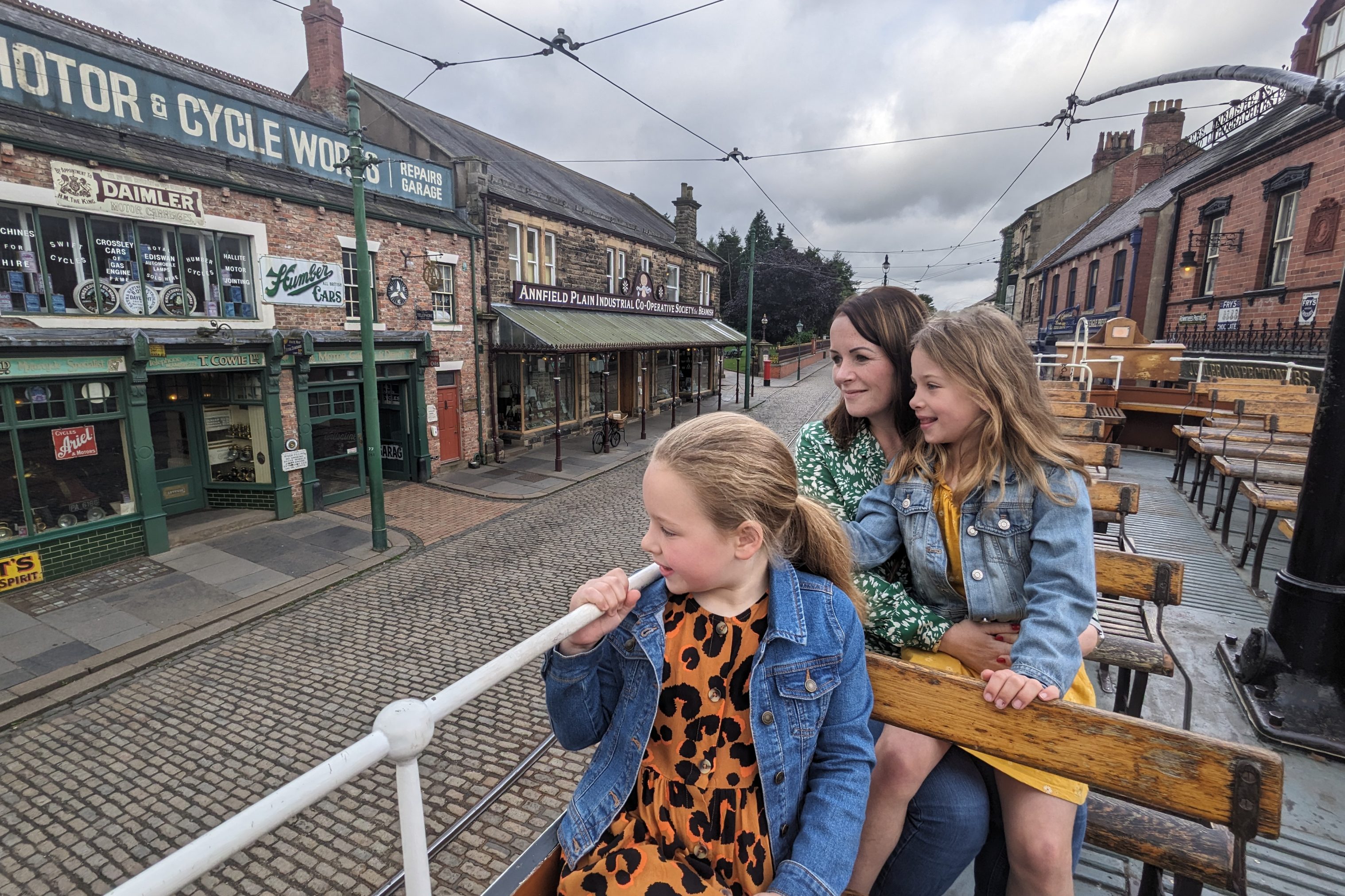 Visitors riding on the top deck of a tram