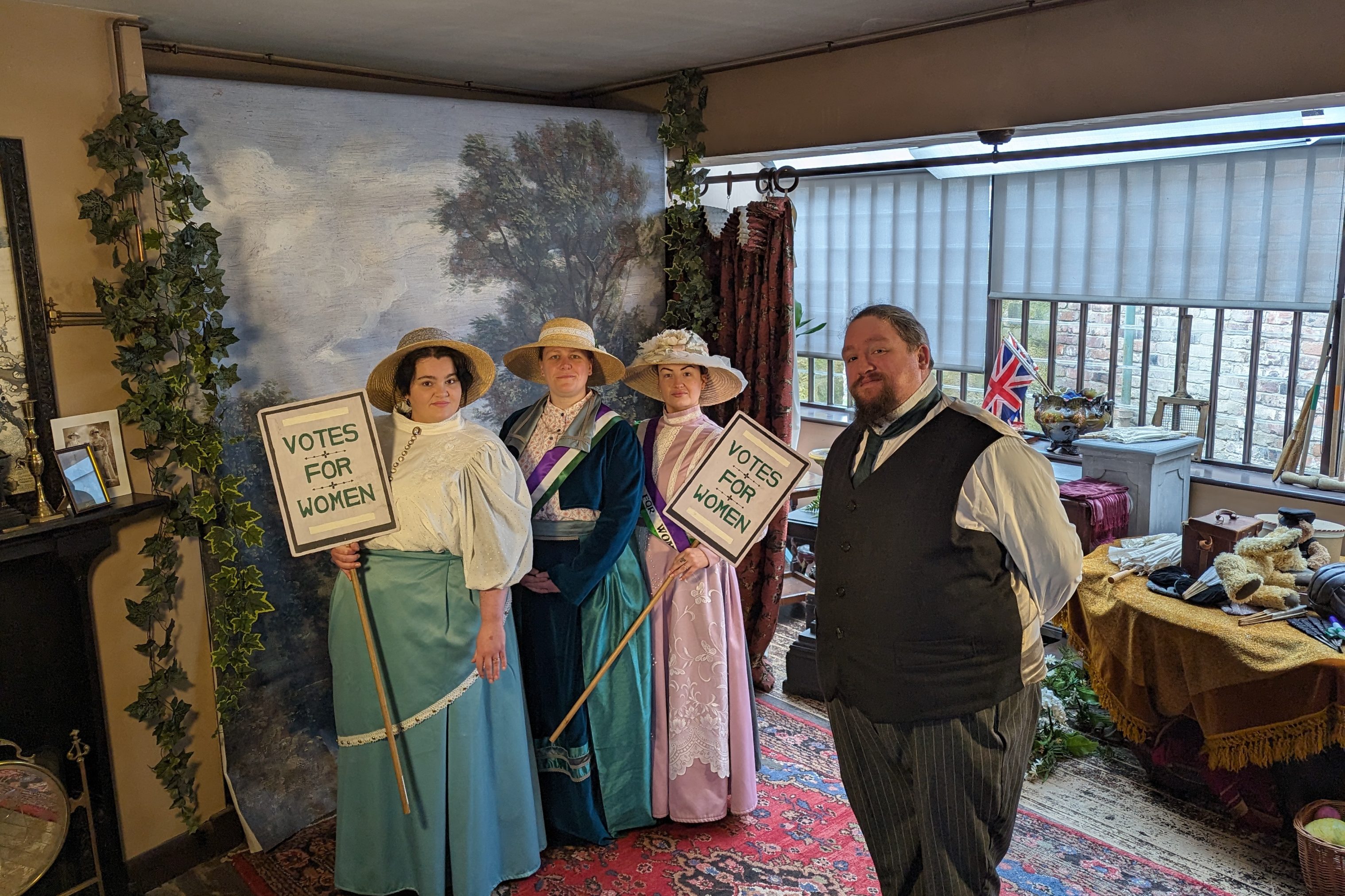 Figures dressed in Edwardian costume.