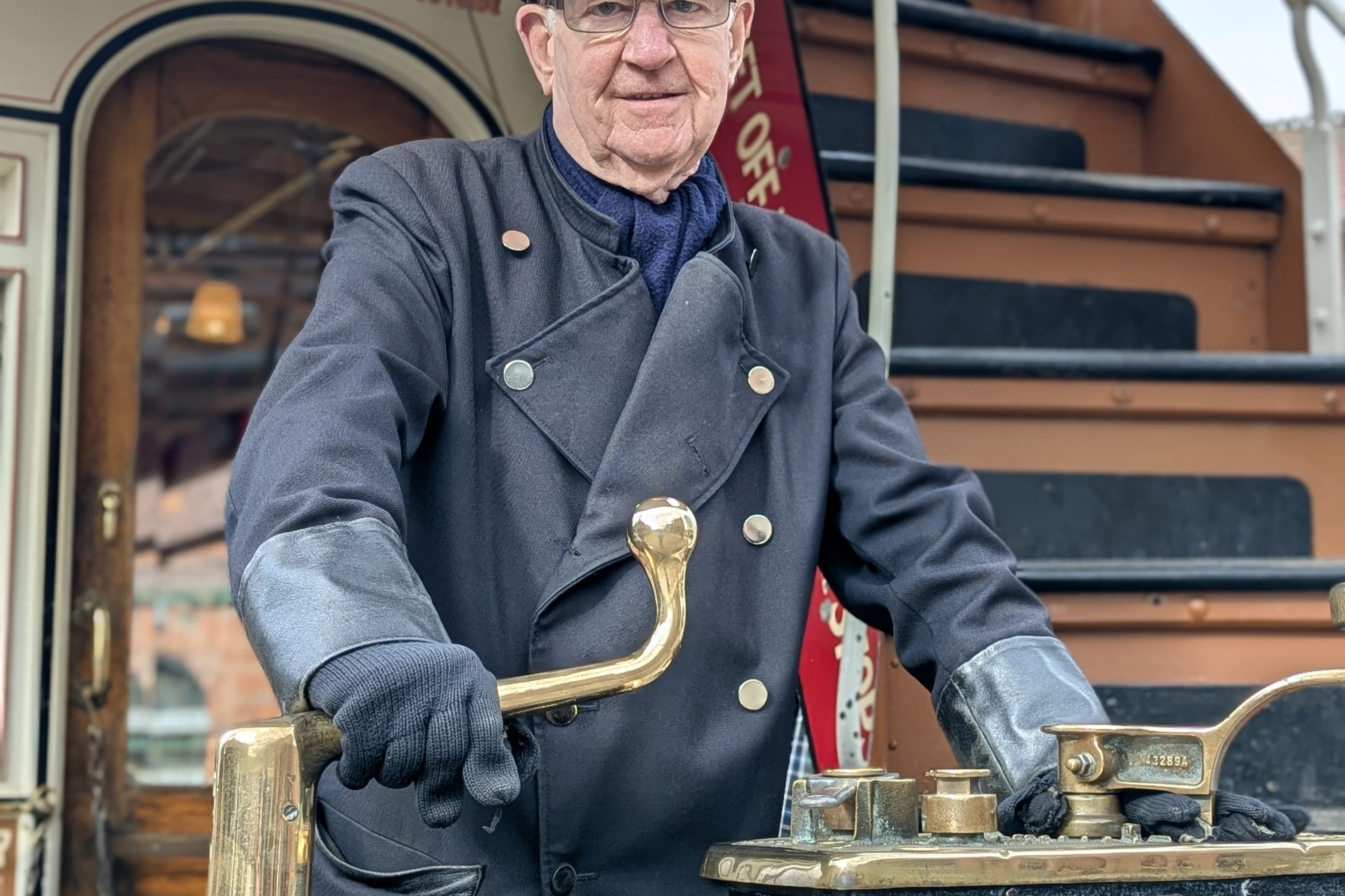 Costumed figure driving tram.