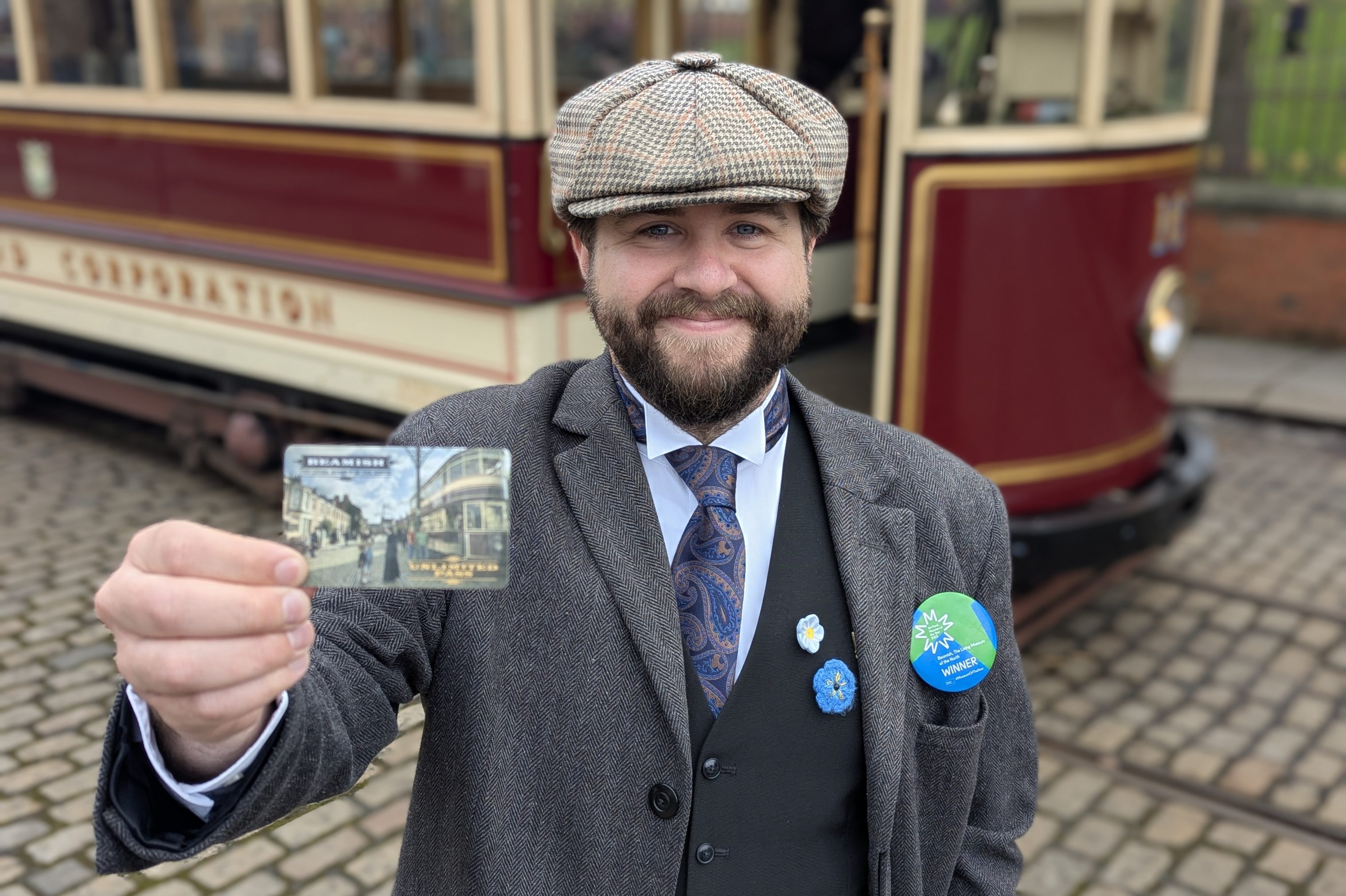 Costumed figure holding Unlimited Pass.