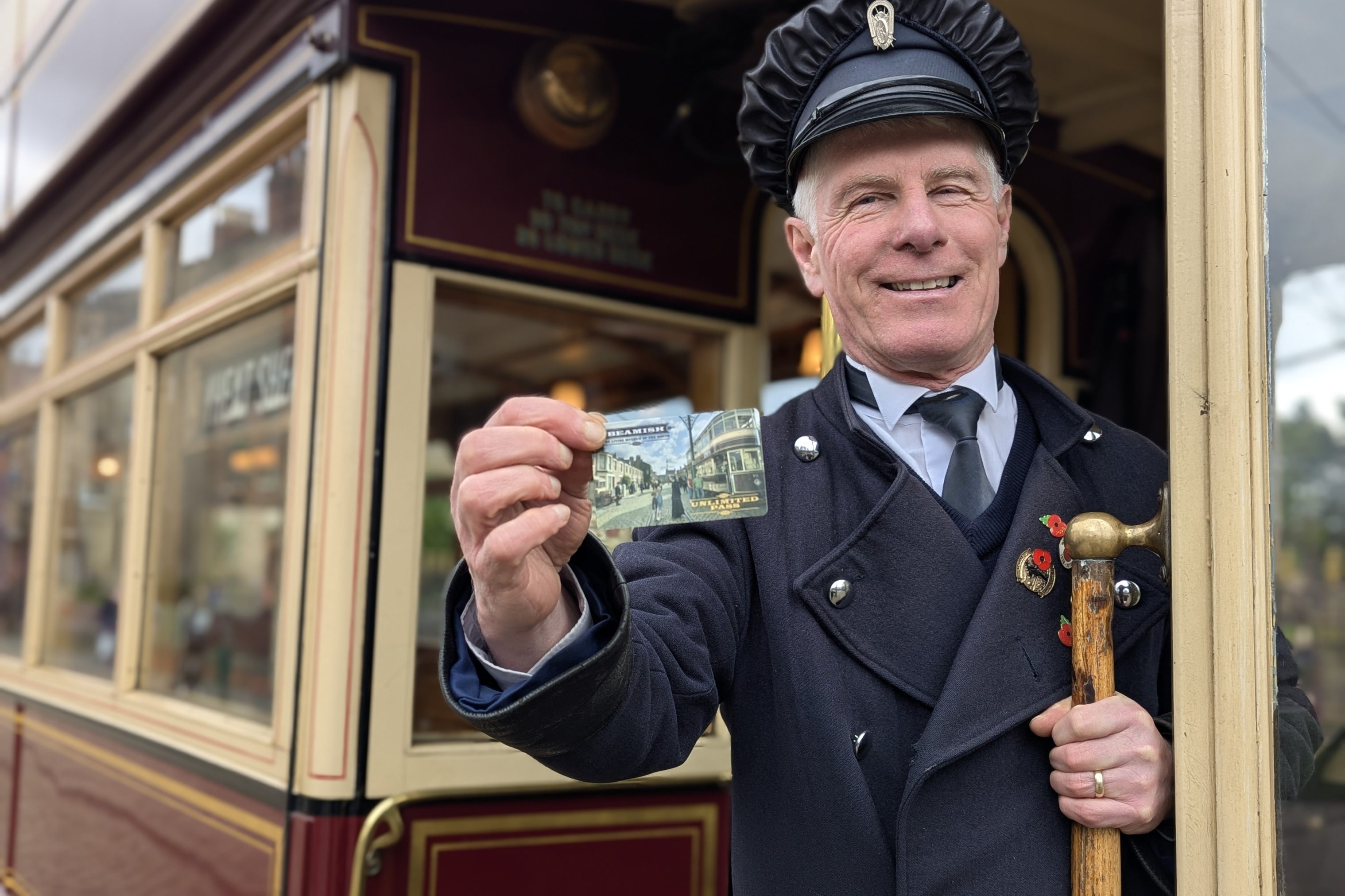 Costumed figure holding Unlimited Pass.