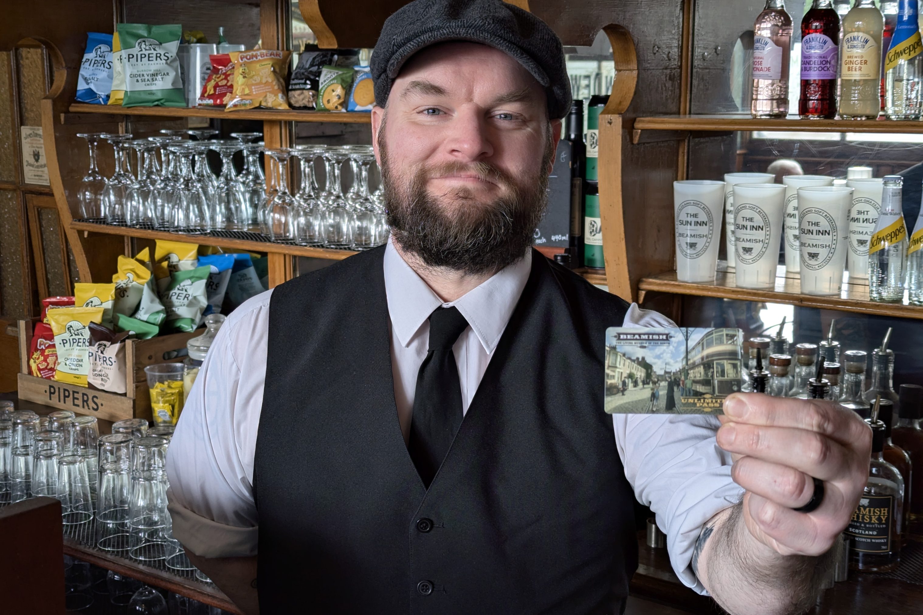 Costumed figure holding Unlimited Pass.