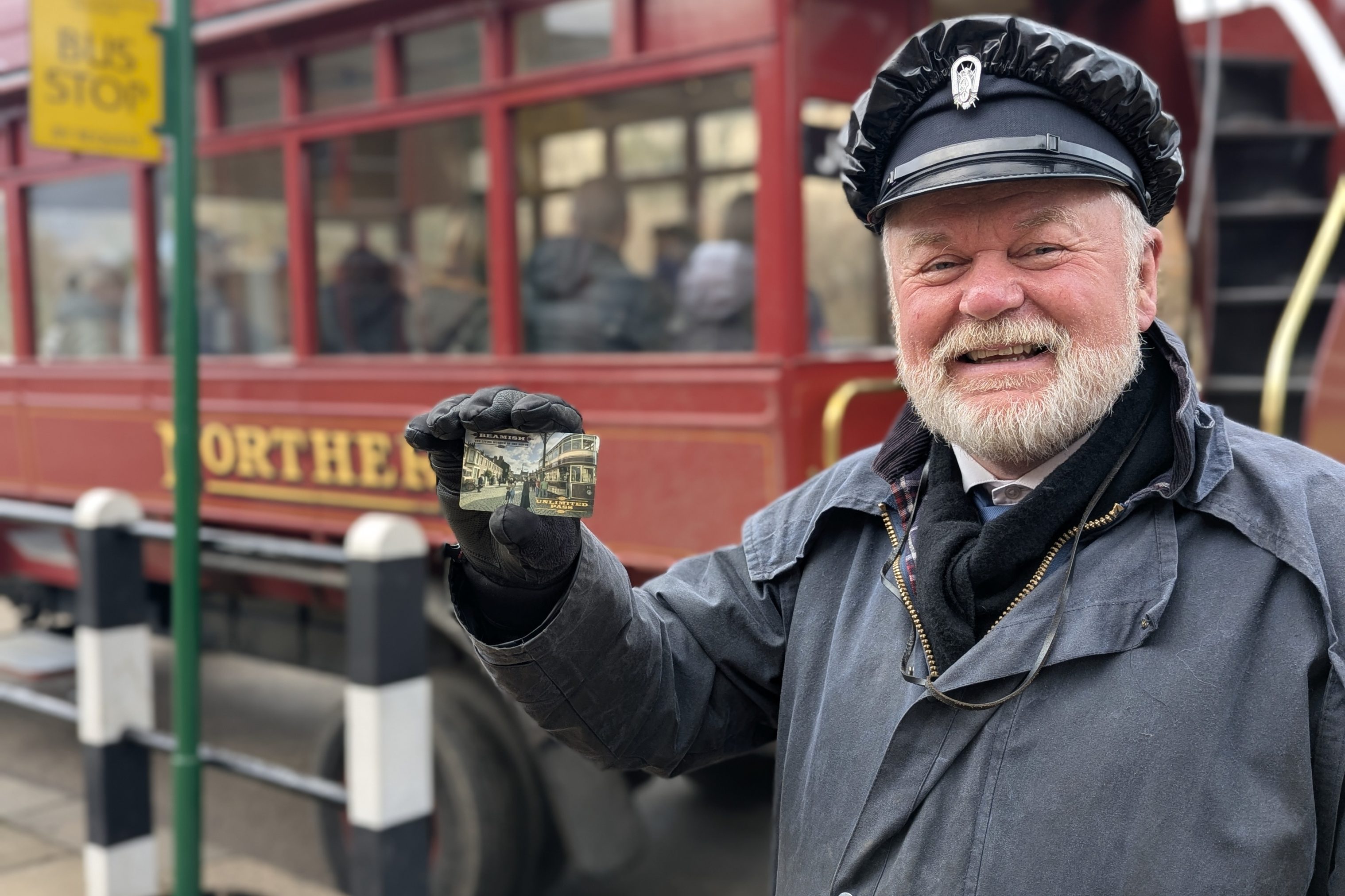 Costumed figure holding Unlimited Pass.