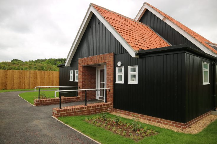 Black wooden panelled building.