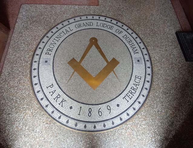 Close up of mosaic circle and logo.