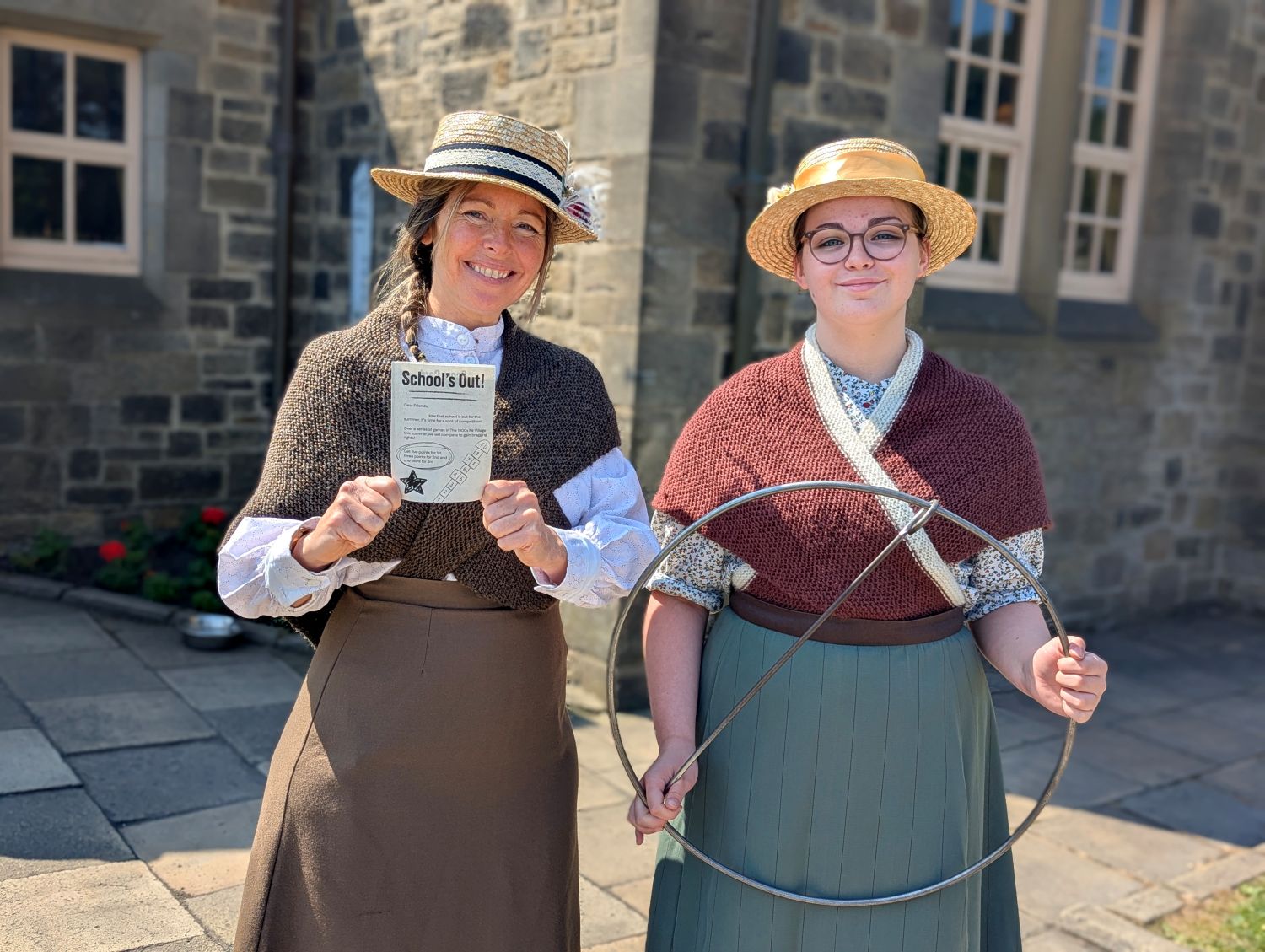Two staff in costume in pit village