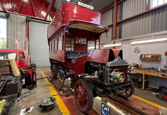 Vintage bus with engine exposed.