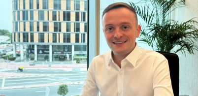 Robbie Smith Mechanical Engineer featured at his desk in our Dubai Office at Black & White Engineering.
