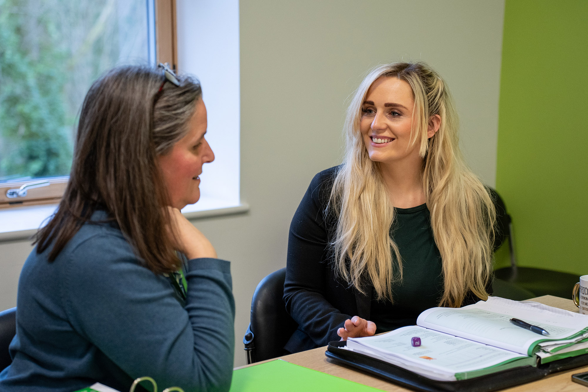 Welsh language adult learner smiling in classroom