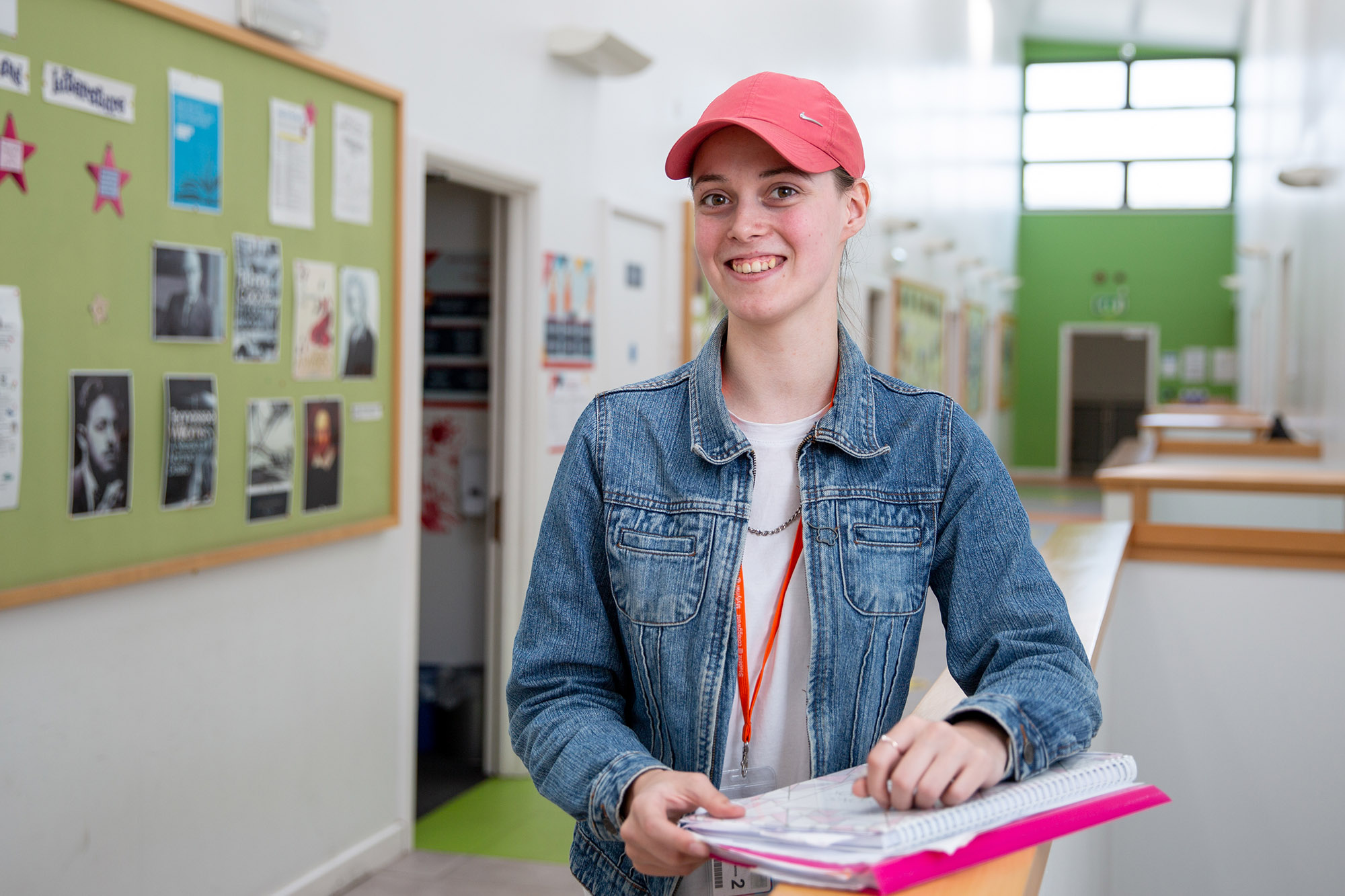 Student smiling in pink cap at Crosskeys Campus