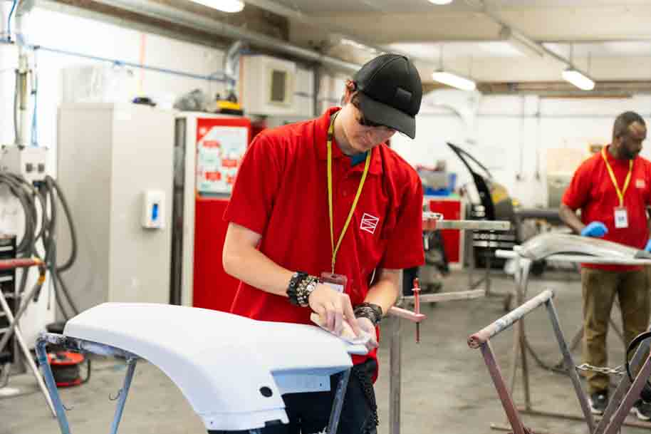 Student smiling whilst working