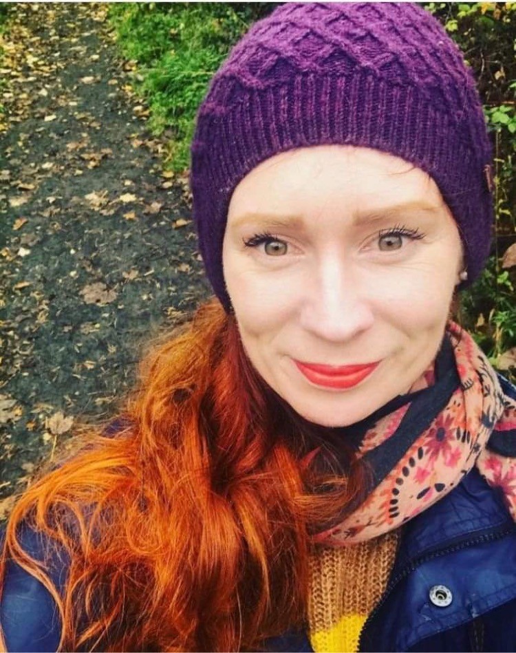 Photograph of Sally Dixon wearing a woolly purple hat