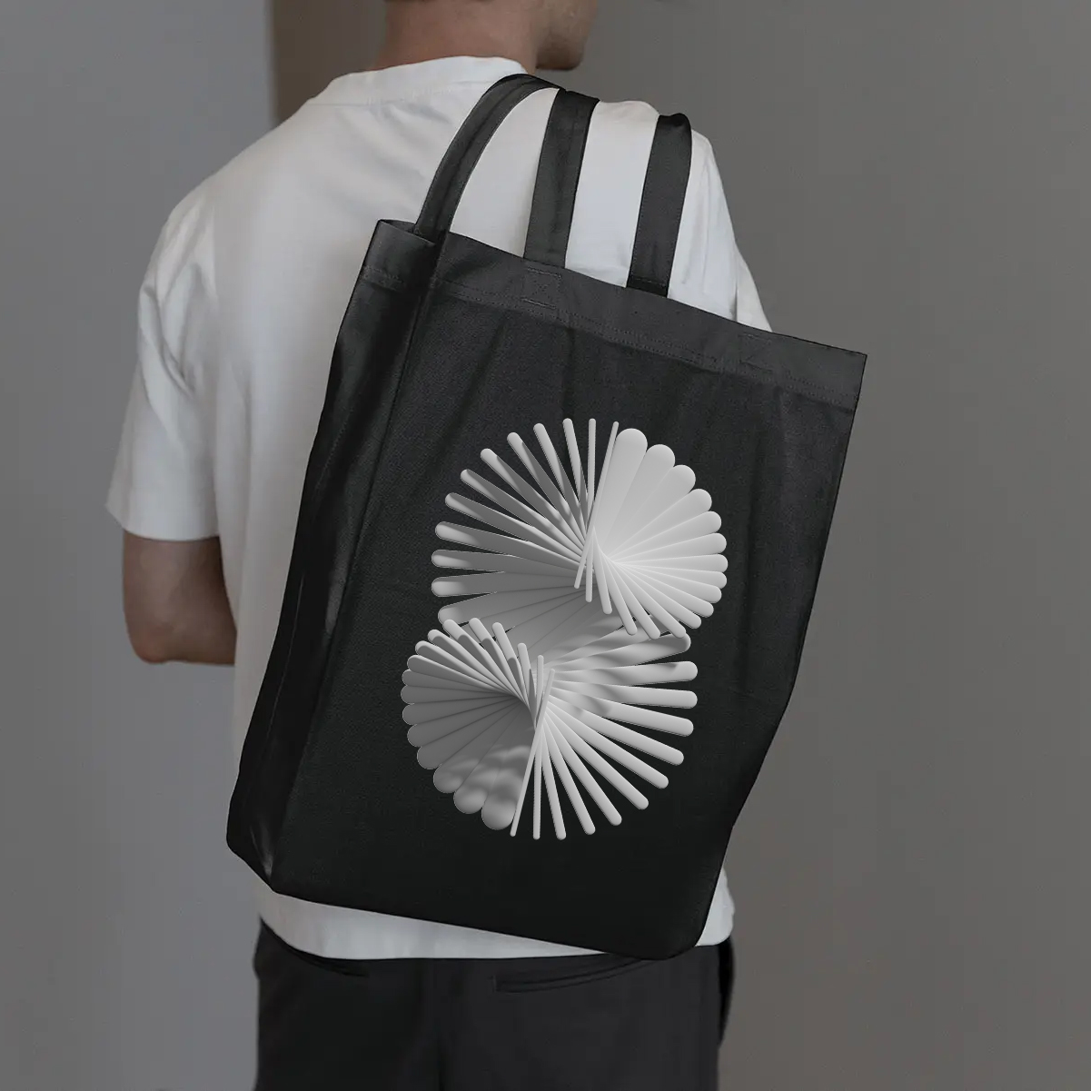 Abstract grayscale 3D spiral on a black tote bag