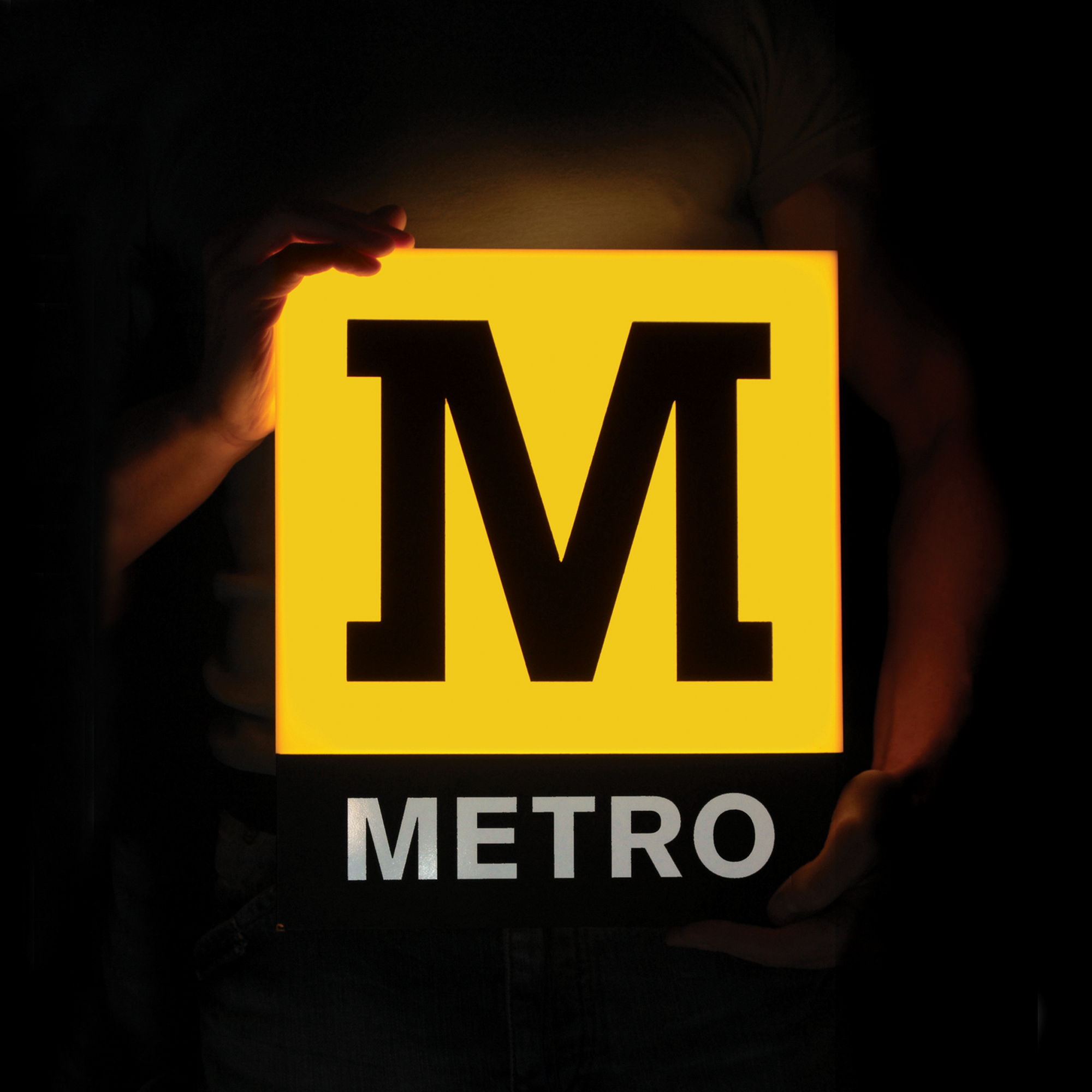 Someone holding a Metro sign